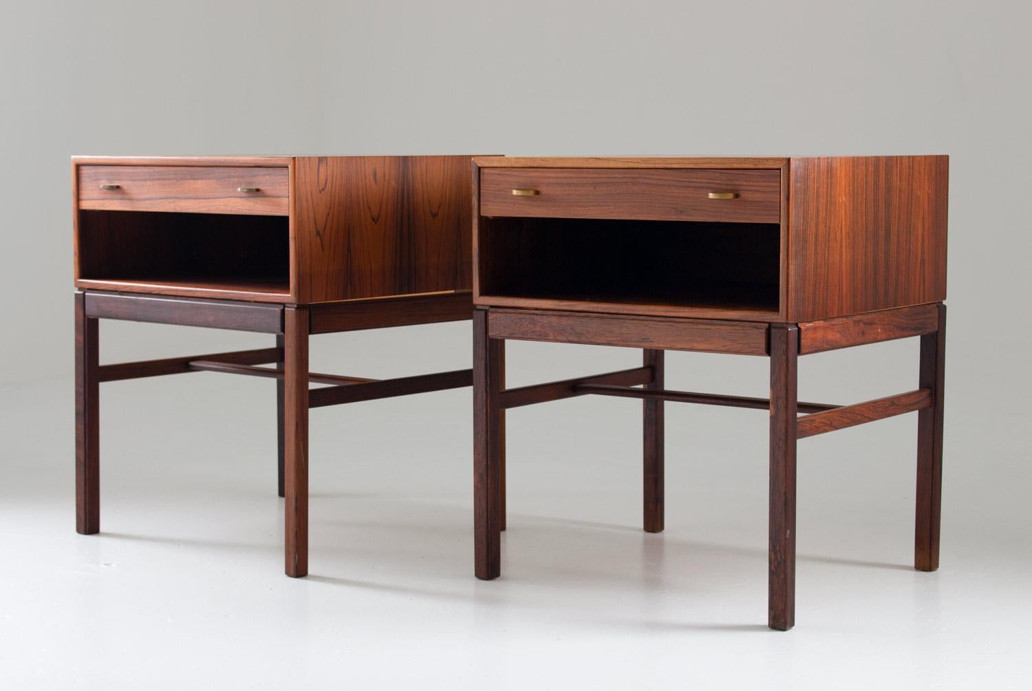 A pair of bedside tables in rosewood with brass details, model Casino by Gunnar Myrstrand and Sven Engström for Tingströms, Sweden, 1960s. 
The tables consist of a drawer on top with an open shelf below. 
Condition: Very good original condition