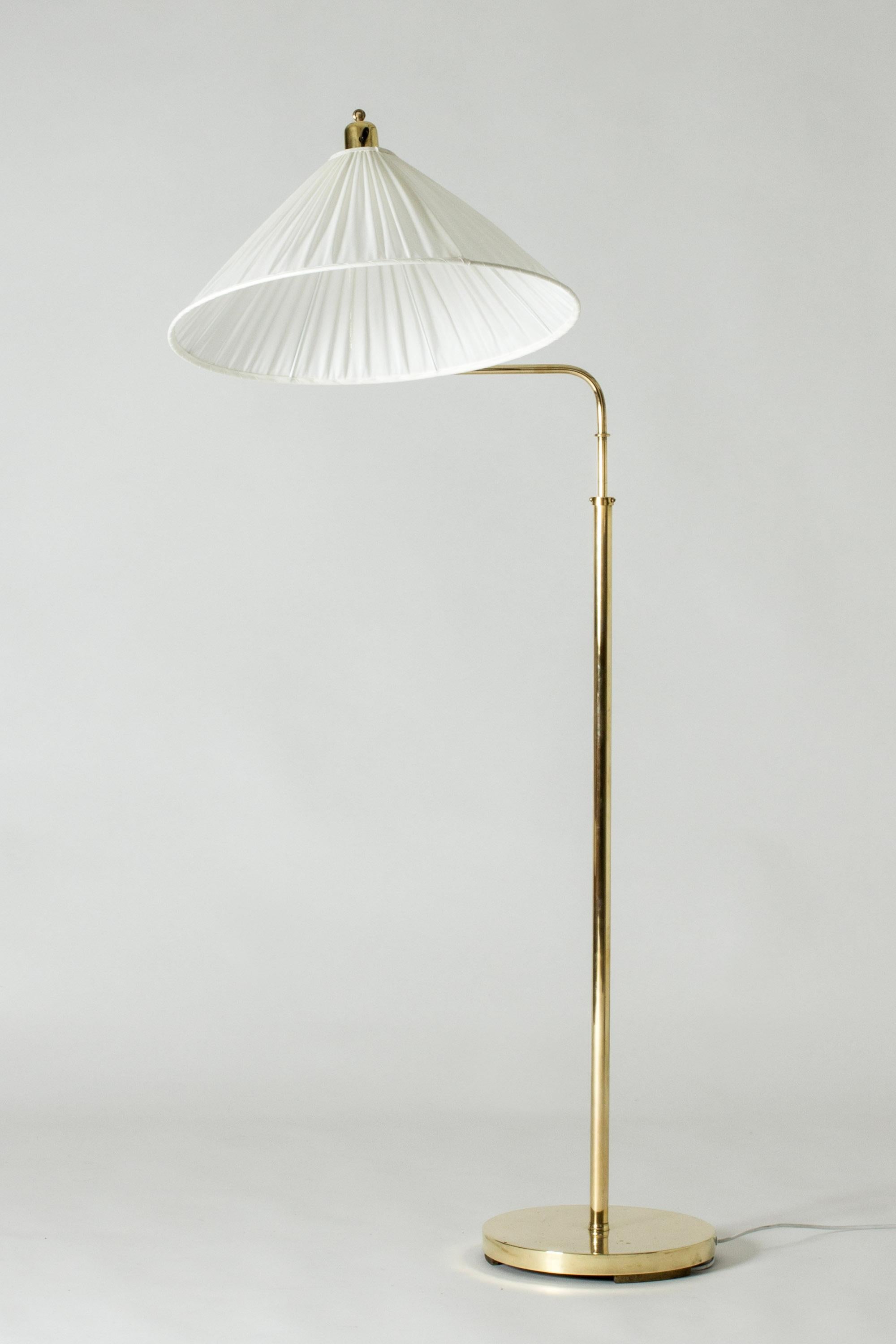 Swedish Modern brass floor lamp with a long neck that can extend and elevate the shade in different directions. Adjustable height. Wide brass base with a solid weight.

Height adjustable between 135 and 185 cm.