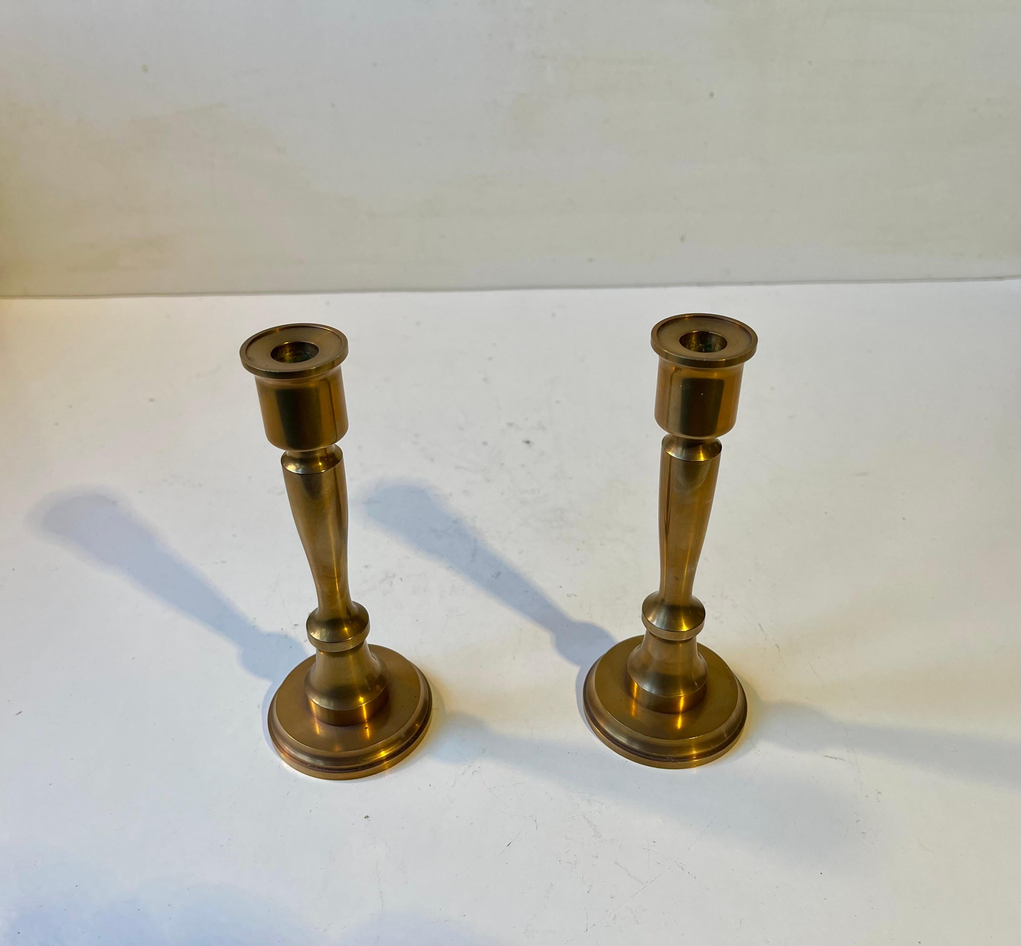 A heavy pair of bronze taper candlesticks executed with architectural features. Designed and manufactured by TH. P. in Scandinavia in 1977. Signed TH. P., 1977. They are to be fitted with 1cm taper candles.  

Measurements: H: 15 cm, D: 6 cm (base).