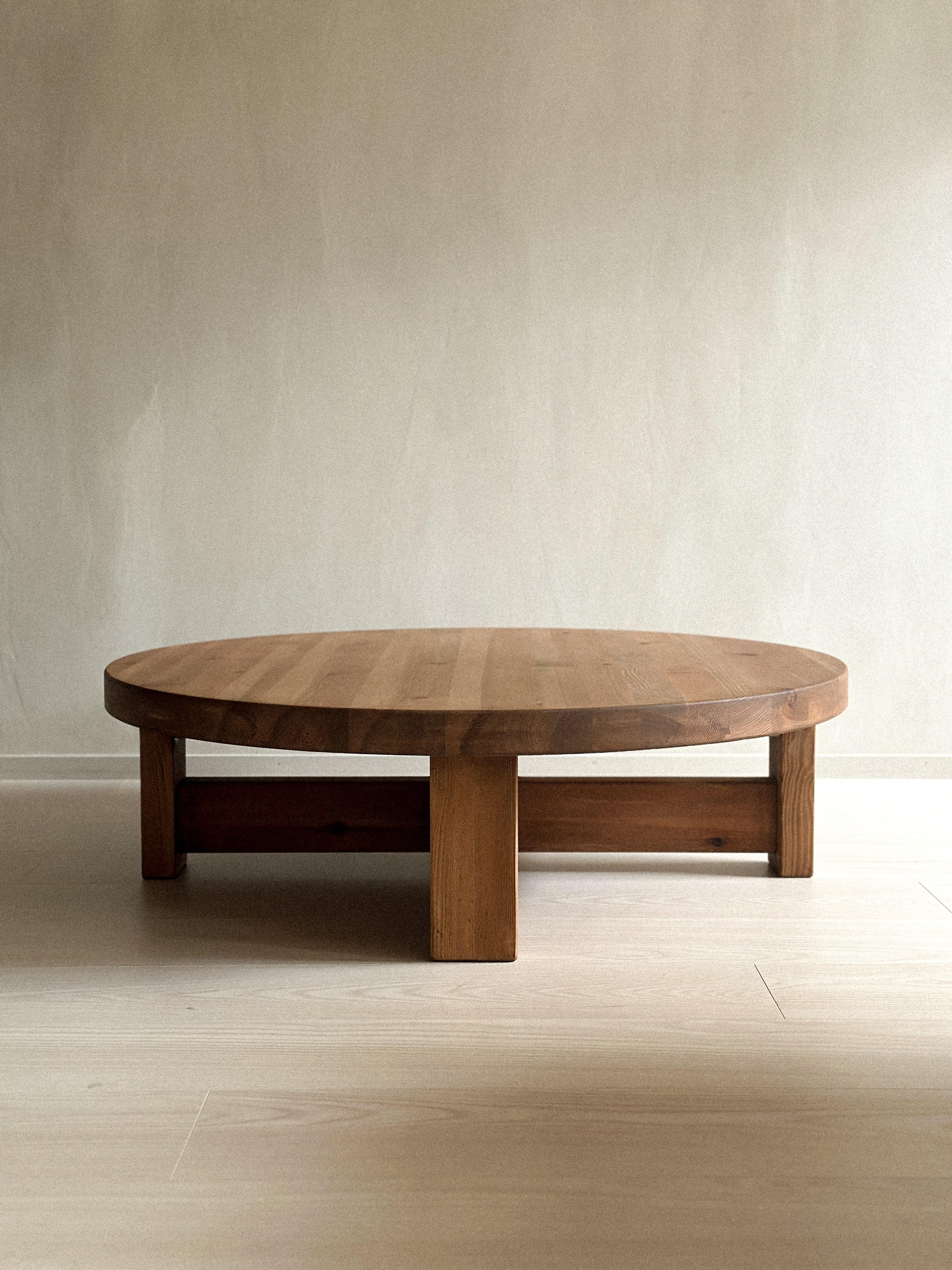This Scandinavian midcentury coffee table from around 1970s, features a light brown stained color and is crafted from solid pine. Its four low square legs add a unique touch of elegance to the design.