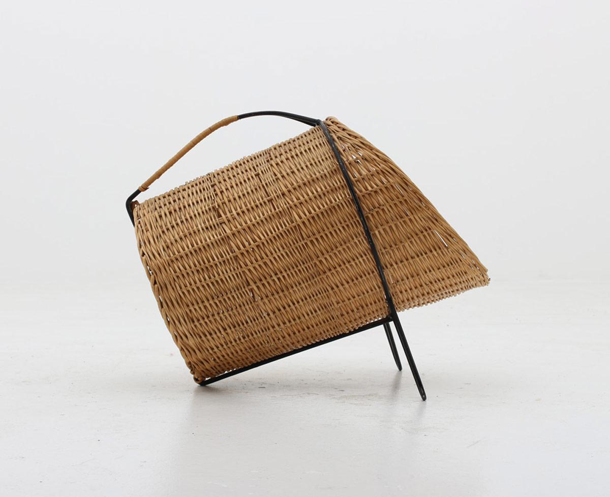 Beautiful firewood basket produced in Sweden, circa 1950.
This basket consists of a round cane tube, held by a beautifully shaped metal stand with a rattan wired handle.
Condition: Good vintage condition. Some cracks and small pieces of cane