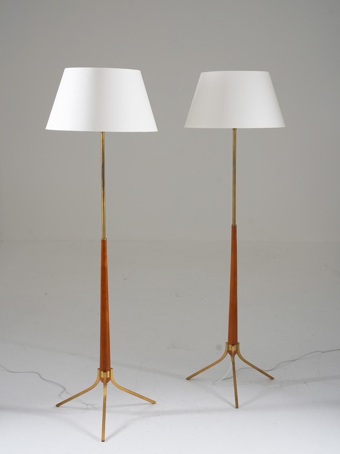 These Scandinavian mid-century tripod floor lamps are a beautiful and unique piece of design. Manufactured in Sweden in the 1950s, these lamps are made of solid brass, with details of teak. They are in very good original condition, with new