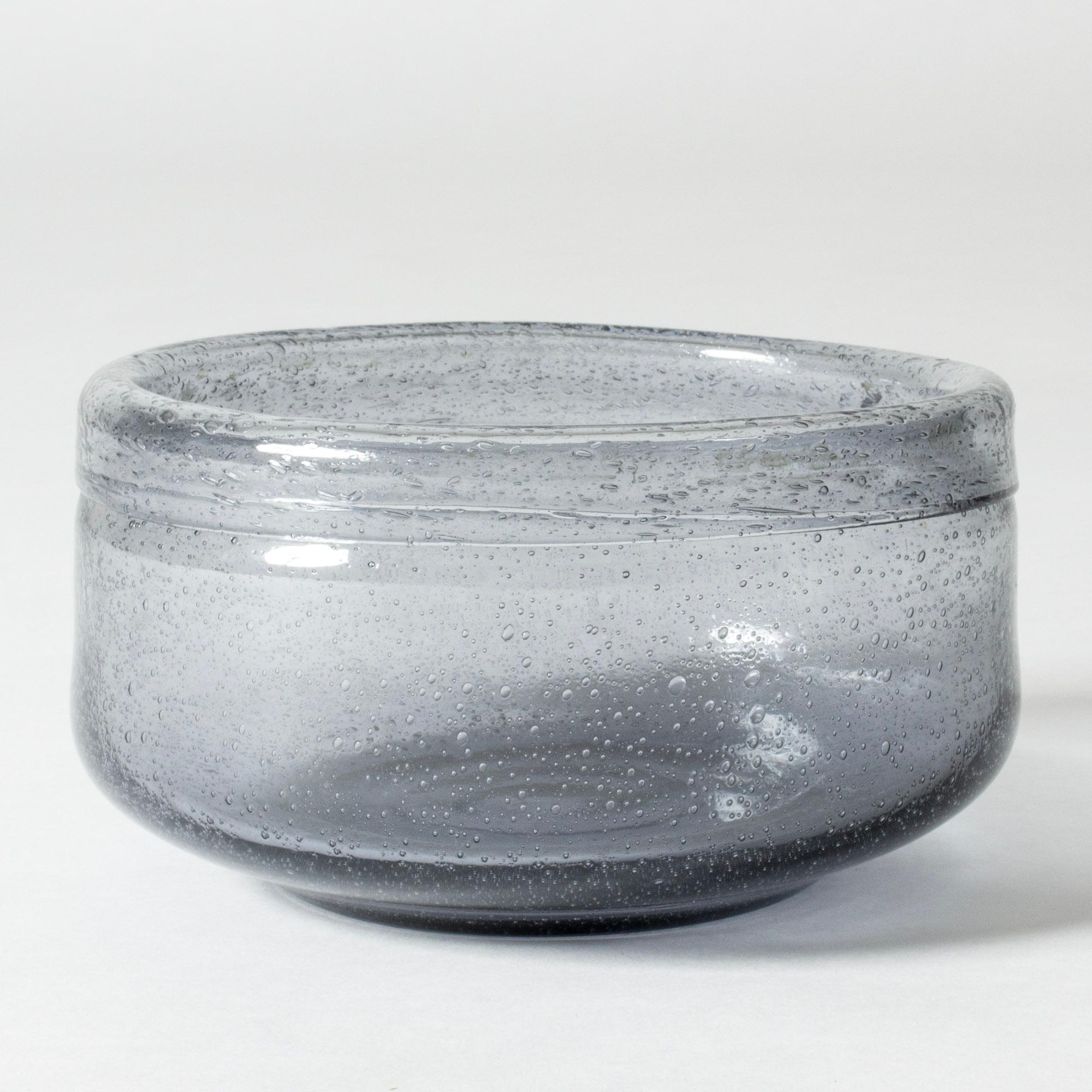 Beautiful, large glass bowl by Erik Höglund, in a cloud grey nuance. Air bubbles encapsulated in the glass create a lively, carbonated look.

Erik Höglund was one of Sweden’s foremost glass artists, whose innovative designs and glass making