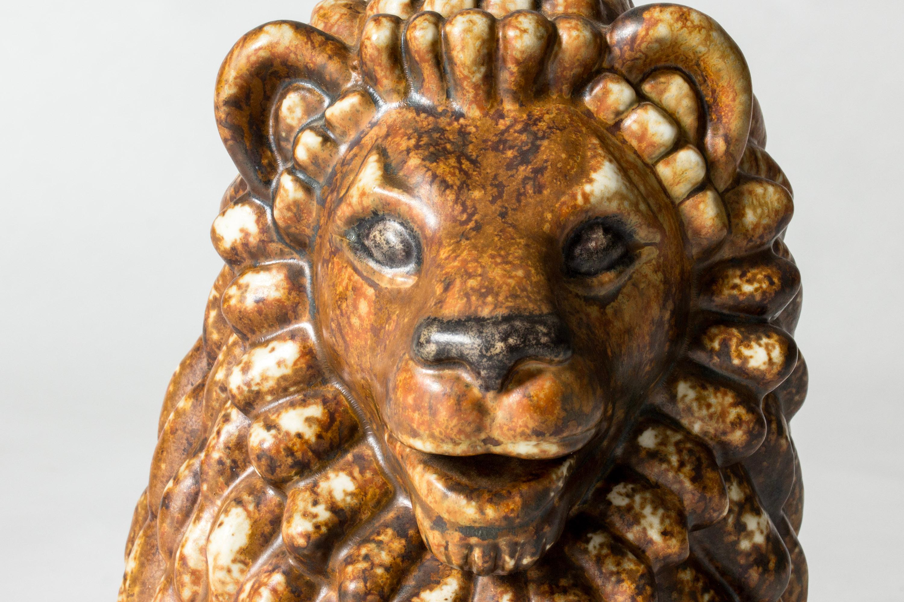 Gorgeous stoneware lion figurine by Gunnar Nylund with an expressive face and glaze gathering beautifully in all its nooks and crannies. Gunnar Nylund’s animal figurines are among his most loved creations, combining naturalistic and modernist