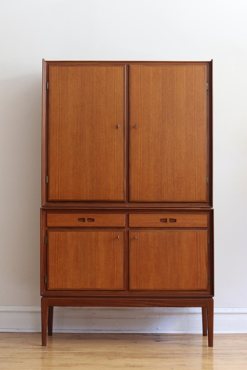 Mid-Century Modern Danish tall teakwood wardrobe/linen cabinet.
Just imported from Denmark.
Very high quality.
Features locking cabinet doors which hold adjustable shelving.
Includes four vintage keys which lock doors.
Two drawers in the