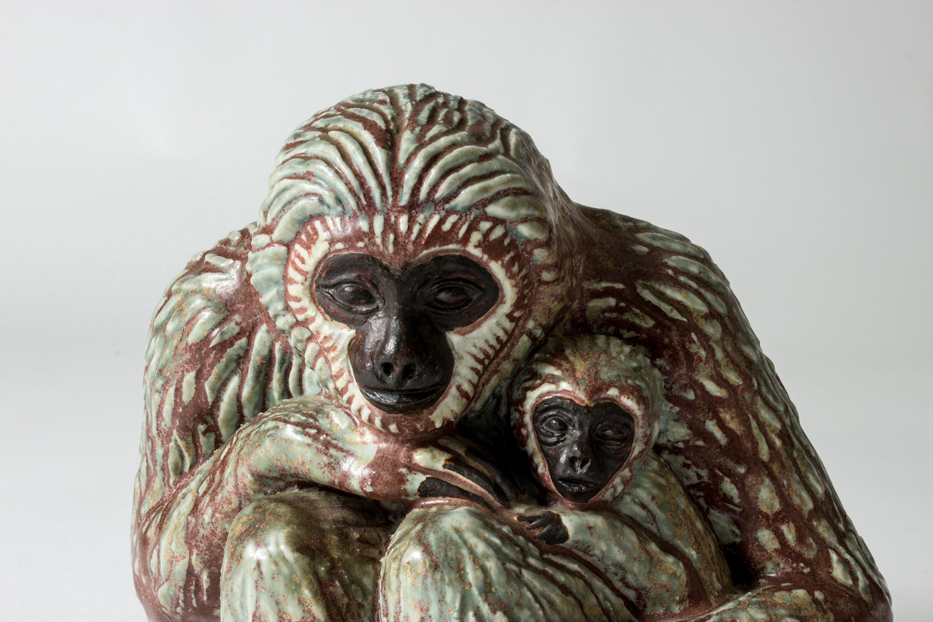 Lovely stoneware figurine by Gunnar Nylund, depicting a monkey mother with its baby cradled in its arms. Beautifully sculpted, with a spirited, protective expression. Greenish glaze mixing with oxblood.

Gunnar Nylund’s animal figurines are among