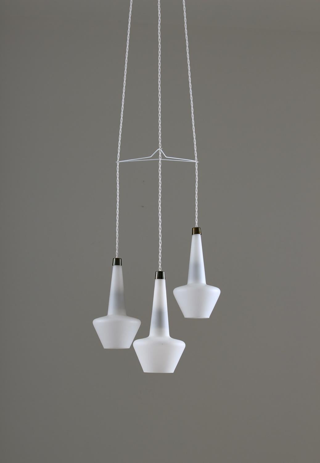 Wonderful rare pendant model T272, in opaline glass by Hans-Agne Jakobsson, 1950s
The lamp consists of three glass pendants connected by a divider in white painted metal. The light spreads beautifully from the opaline glass shades.

Condition: