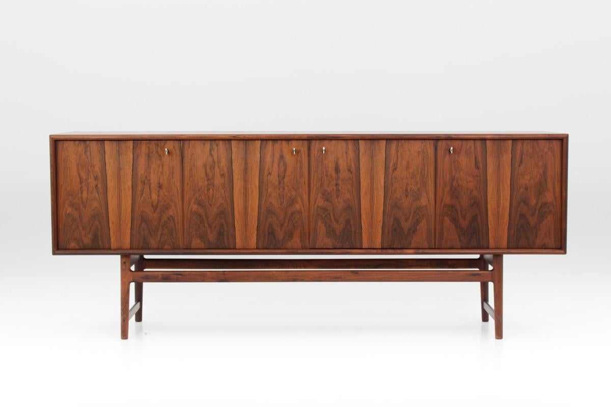 Rare sideboard in rosewood by Norwegian designer Torbjørn Afdal for Nejestranda Møbelfabrik. 
This sideboard is a true masterpiece that rarely appears on the market. The sideboard features four doors that are tightly fitted side by side, creating a