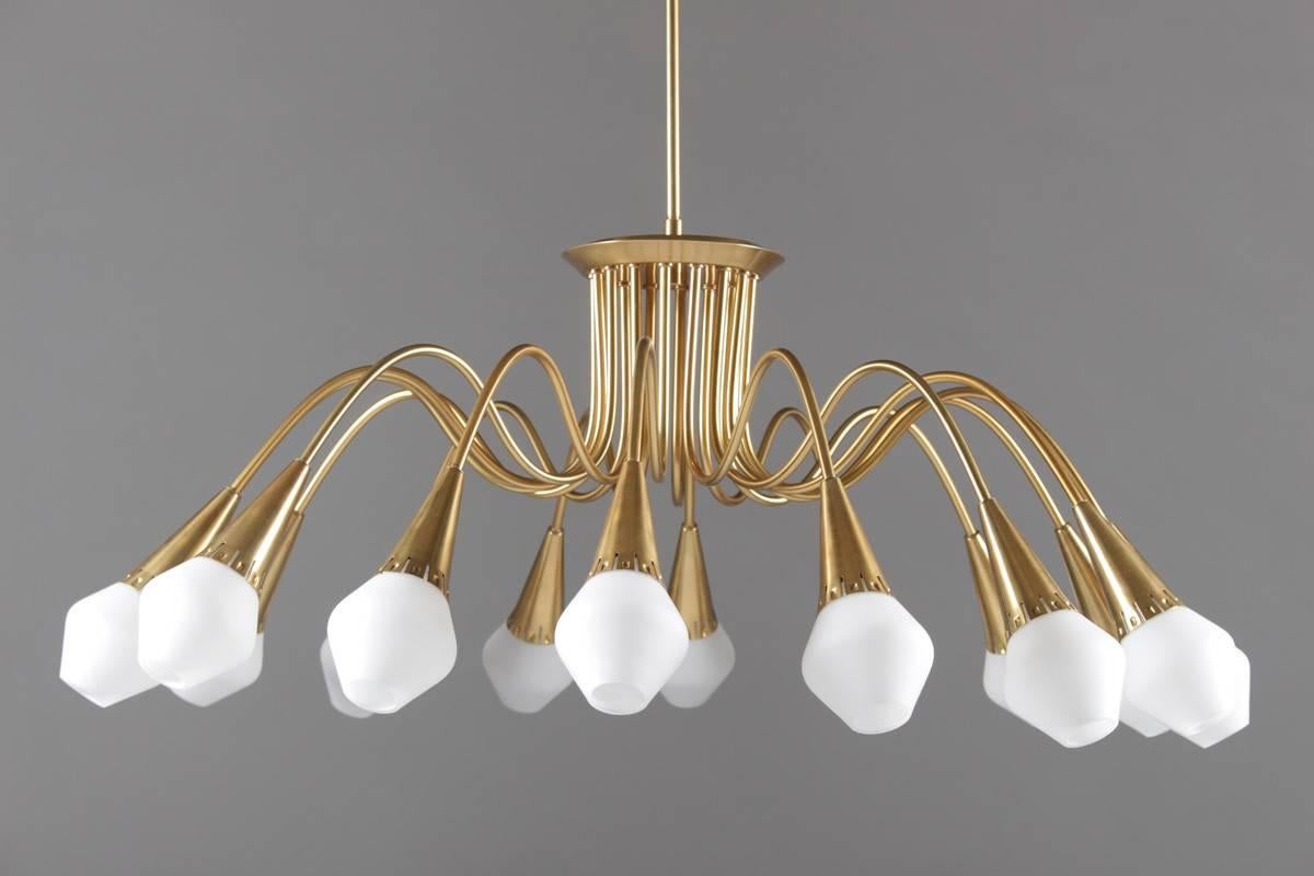 Very rare, large chandeliers made of brass with shades in opaline glass manufactured by Böhlmarks Lampfabrik, Sweden.
These chandeliers came from a cinema built in the early 1950s. We also have a floor lamp with the manufacturer's stamp.
Each lamp