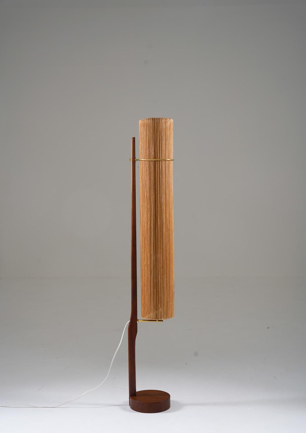 Scandinavian midcentury floor lamp in teak and brass, by Ib Fabiansen for Fog & Mørup, Denmark
This lamp consists of a teak base with brass details, supporting the large cylinder-shaped shade.

Condition: Very good original condition.
