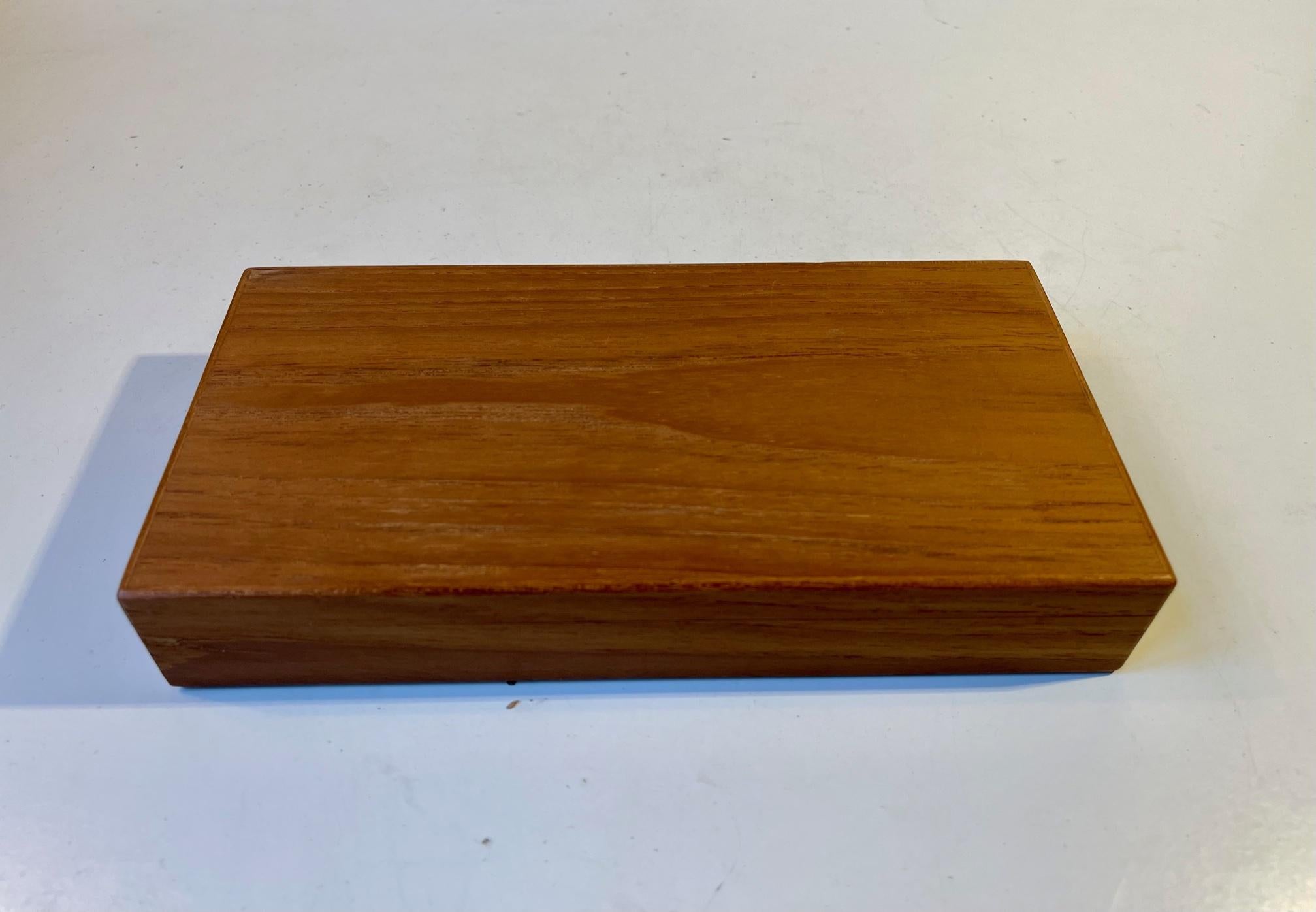 A wellmade solid teak box with one large compartment lined with cork. Made anonymously in Denmark during the 1960s in a style reminiscent of Alfred Klitgaard, Kay Bojesen and Finn Juhl. Measurements: 22 x 11 x 4 cm.