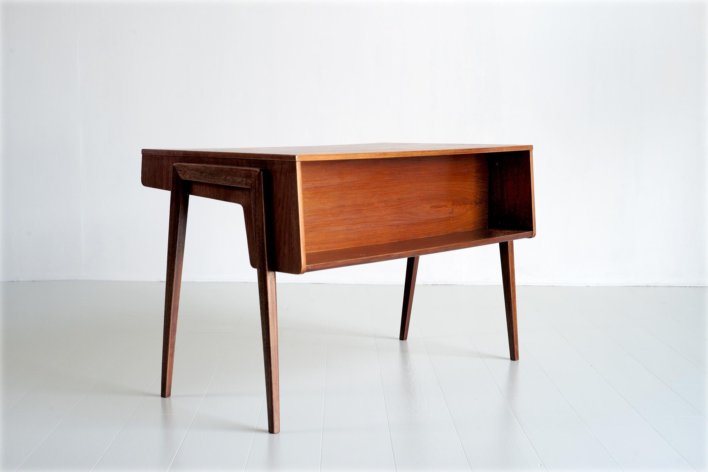 Scandinavian desk in teak and maple, 1960. Mounted on a portico base, the desk consists of a library on the visitor side and two drawers in the belt. The purity of the lines and the execution give this desk a timeless elegance. Very good condition.