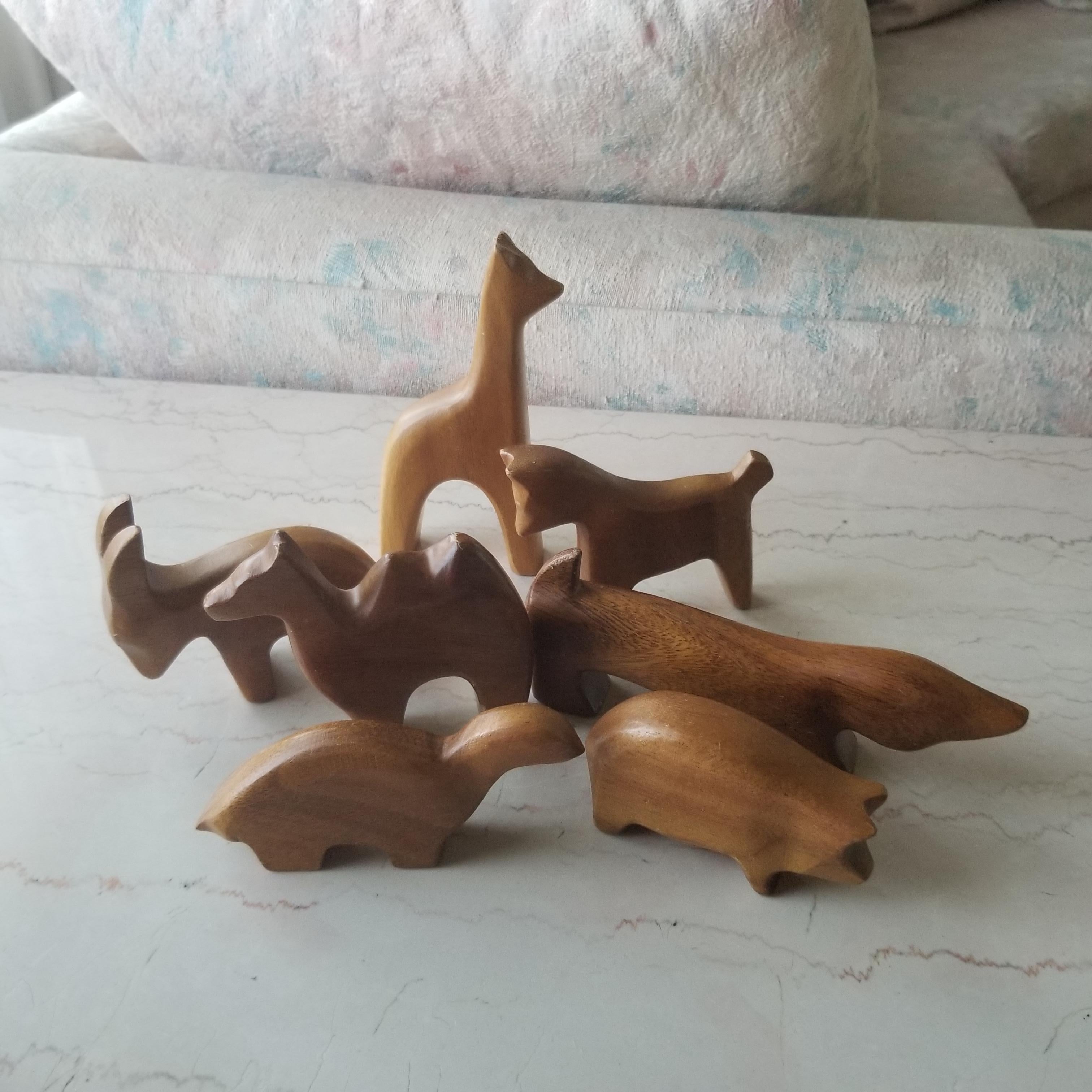 Scandinavian Mid-Century Modern wood animal collection set of seven pieces
Styled after designs of Arne Tjomsland
Includes Dog Giraffe Ibex Camel Pig Turtle Horse
Set includes seven carved wooden animals
Measurements assorted from 6.5 W x 5.5 T