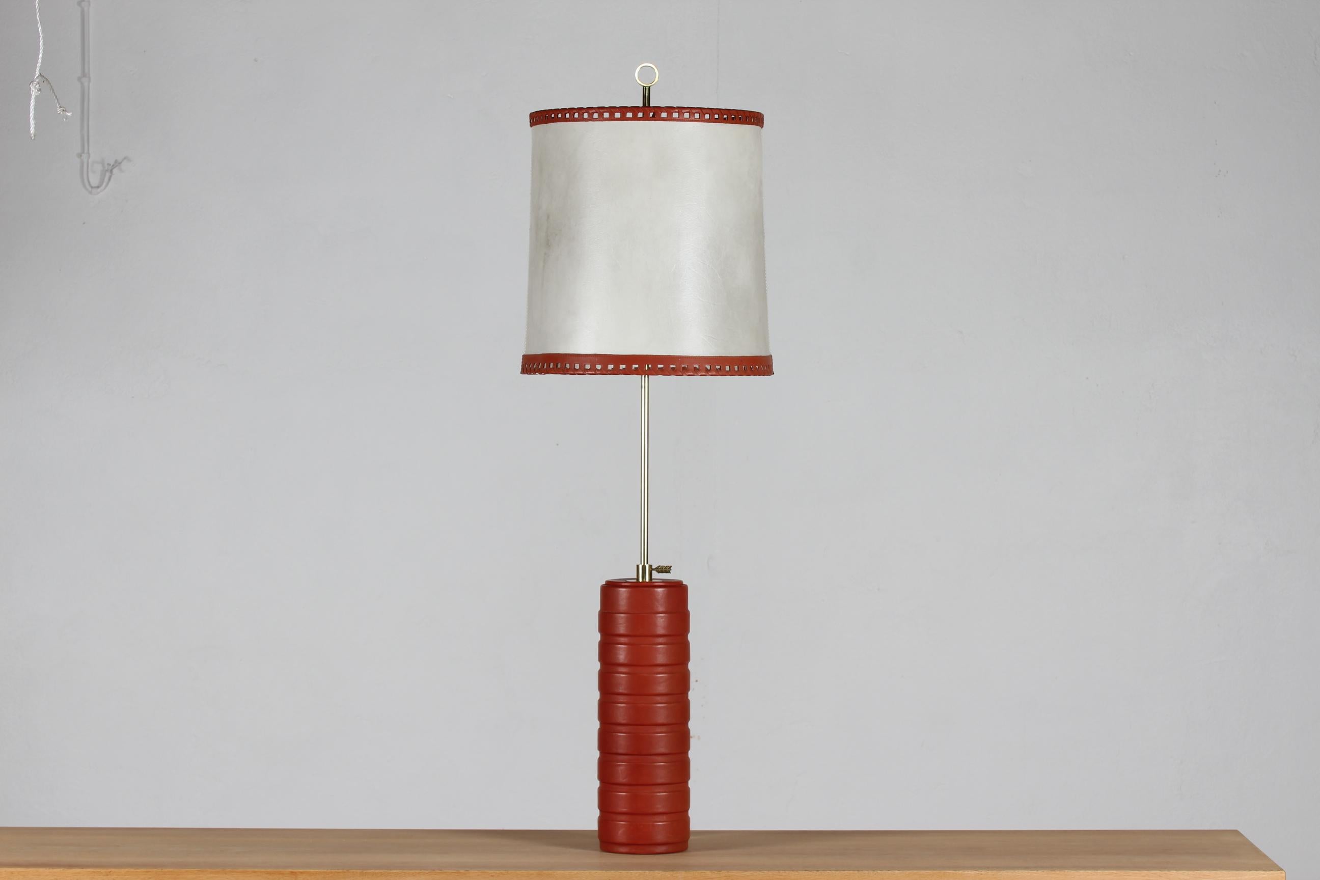 Mid century Scandinavian light design.

Tall and large height adjustable table or desk lamp from the 1960´s - even large enough for floor use
It is made of red-brown leather with an off white leather shade and with fittings of