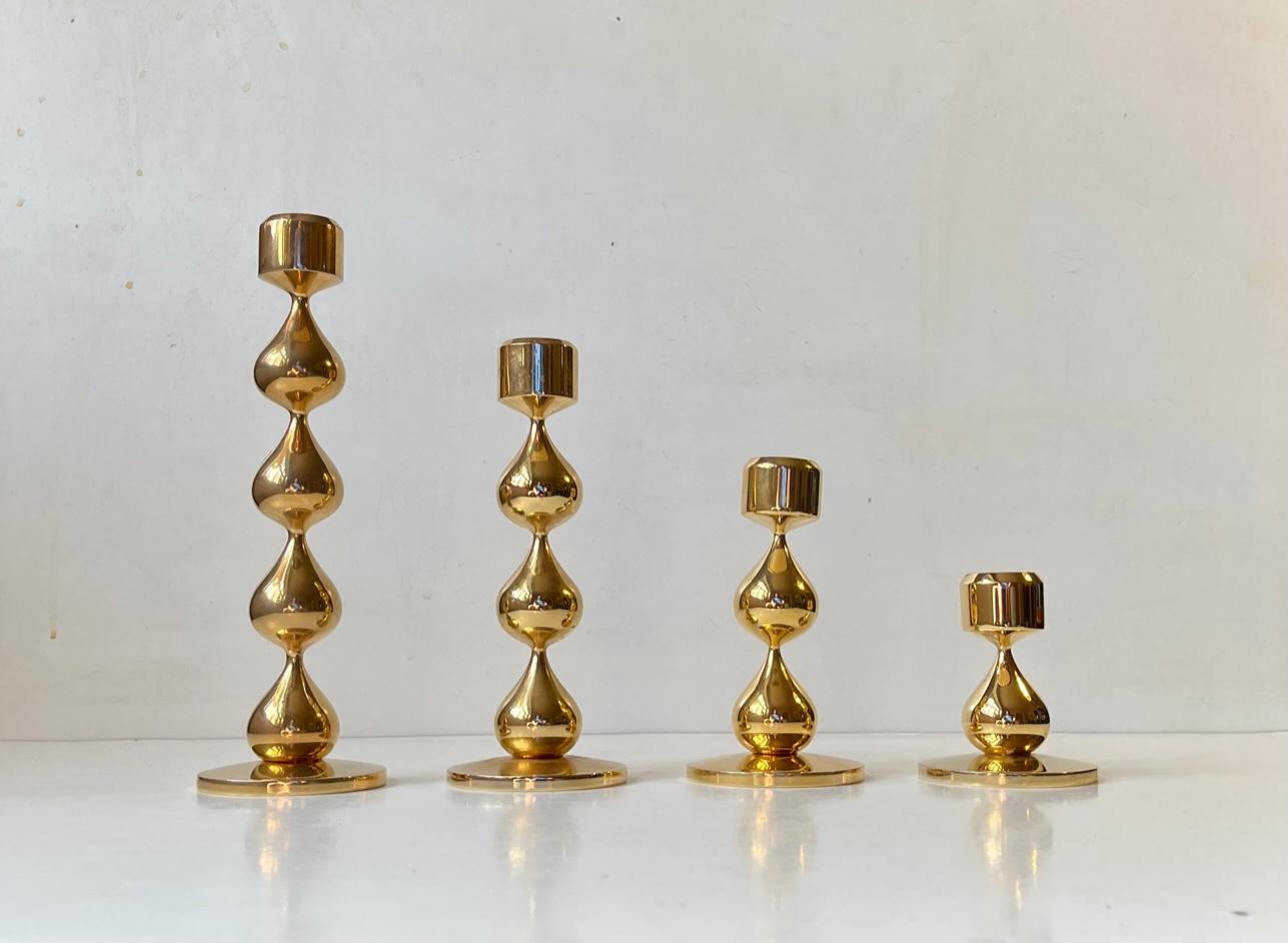 A complete series of teardrop candleholders, with 1-4 teardrops combined in to one group of 4. These organically shaped beauties are covered in 24-carat gold-plating. Designed by Hugo Asmussen and manufactured by Asmussen in Denmark during the