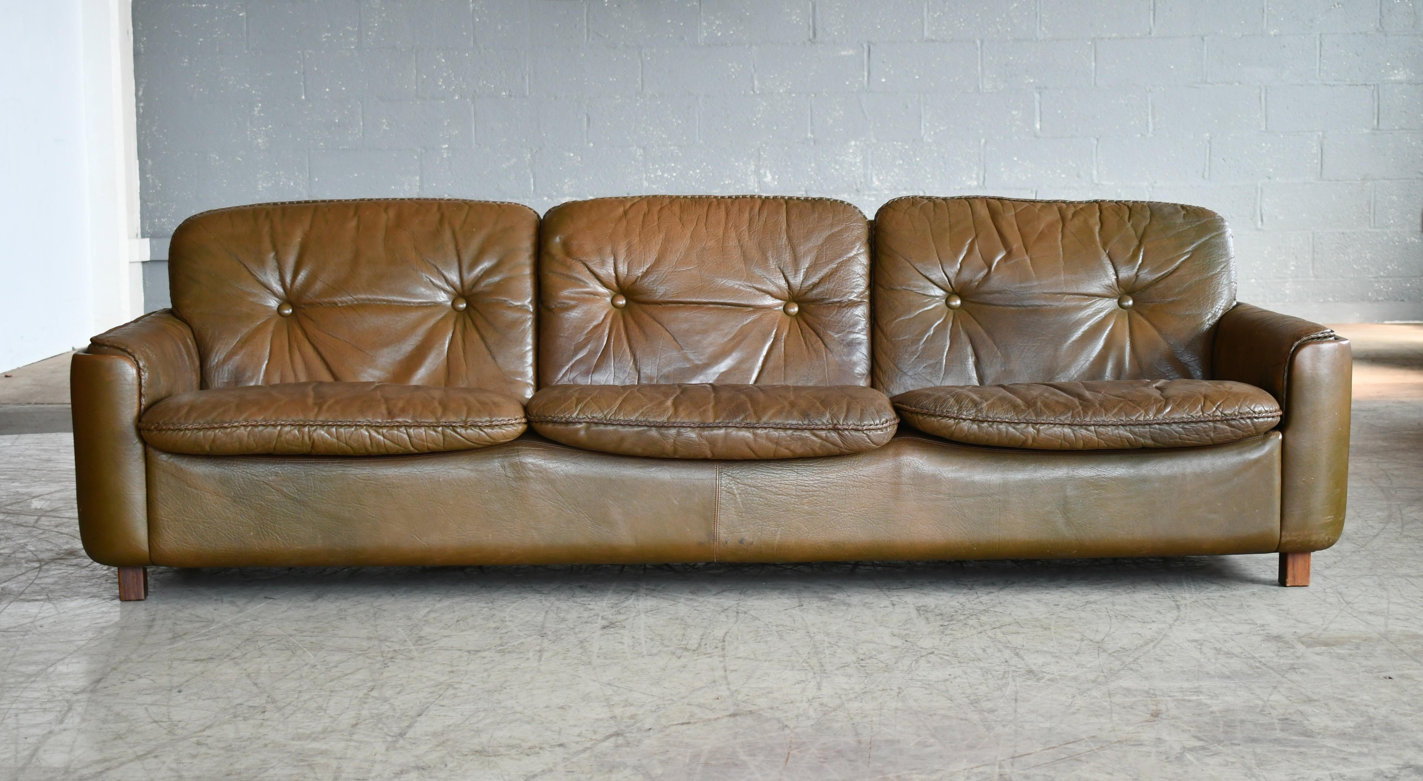Beautiful high quality Scandinavian Modern 3-seat leather sofa in olive brown buffalo leather designed by Sigurd Ressell in the early 1970s for Vatne Mobler of Norway. Thick supple leather showing some beautiful patina and with the original brown