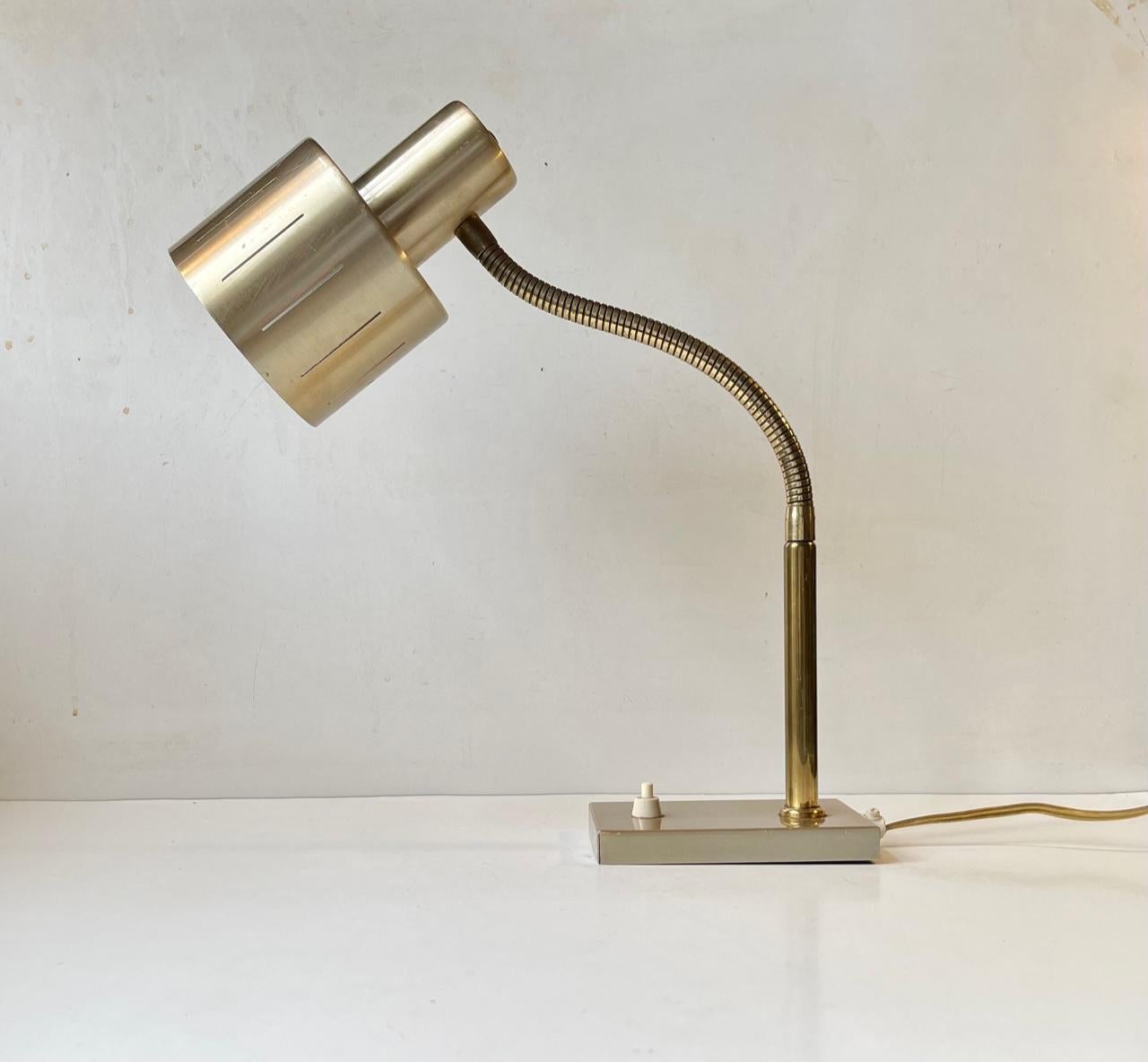 Versatile table lamp from the Danish design-trio Vitrika. Manufactured in the early 1970s in a style reminiscent of Jo Hammerborg for Fog & Mørup. Its made from brass and brass-alloy aluminium. It features flexible swan-neck, shade-perforations and