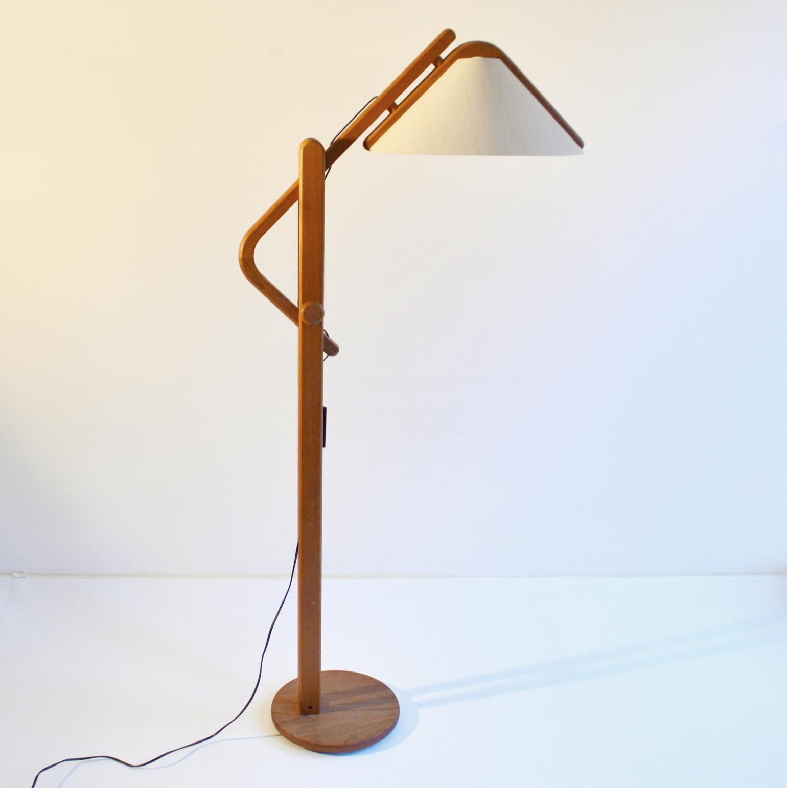 Mid-Century Modern Danish floor lamp with original shade by Domus. The solid teak frame has an adjustable arched arm for perfect positioning of the light. The lamp is designed with clever functional details that are pleasant for the eye and typical