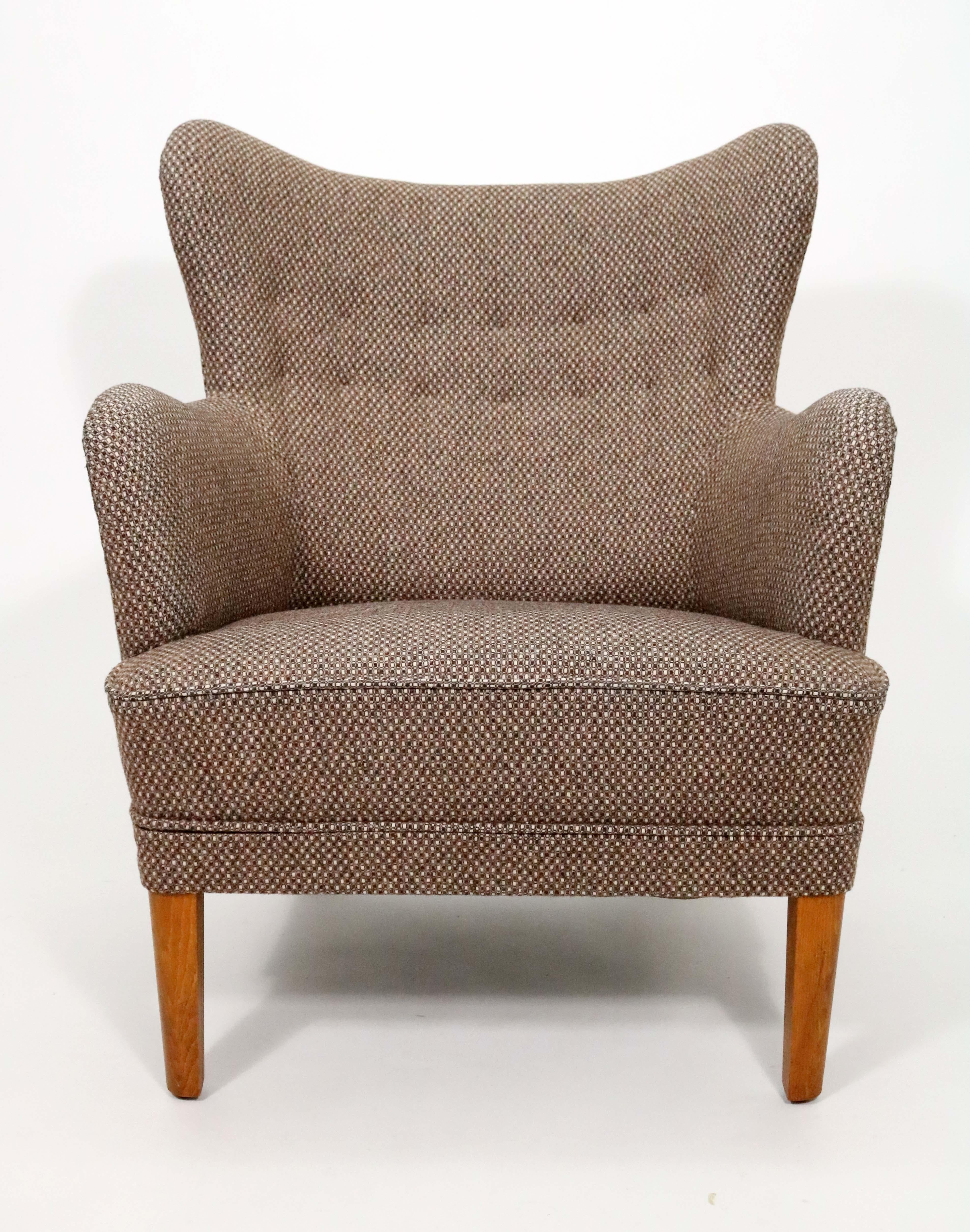 A handsome mid-century Scandinavian chair reflective of Carl Malmsten's take on the classic wingback chair. 

Heavy wool upholstery.
