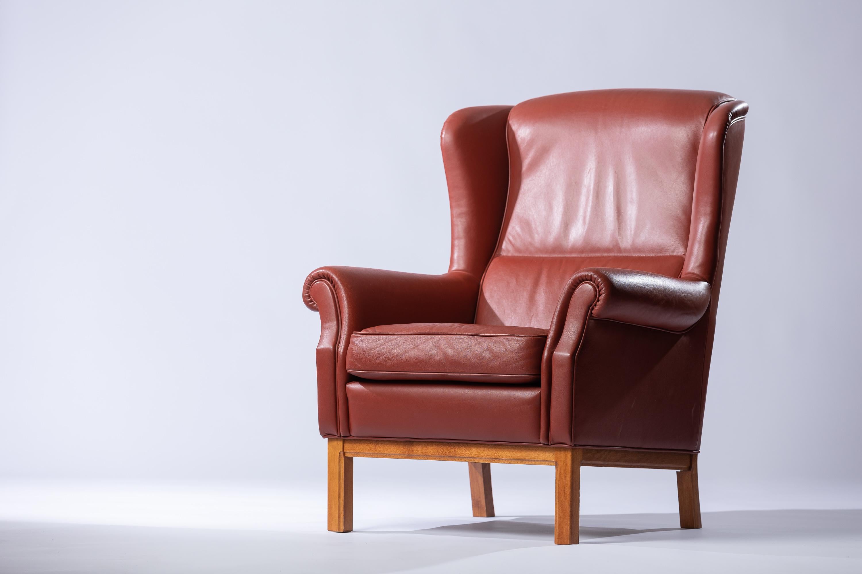 Elevate your interior with the Scandinavian Modern imitation leather armchair crafted by the legendary designer Arne Norell. This iconic piece embodies the essence of Scandinavian design, characterized by its clean lines, functionality, and timeless