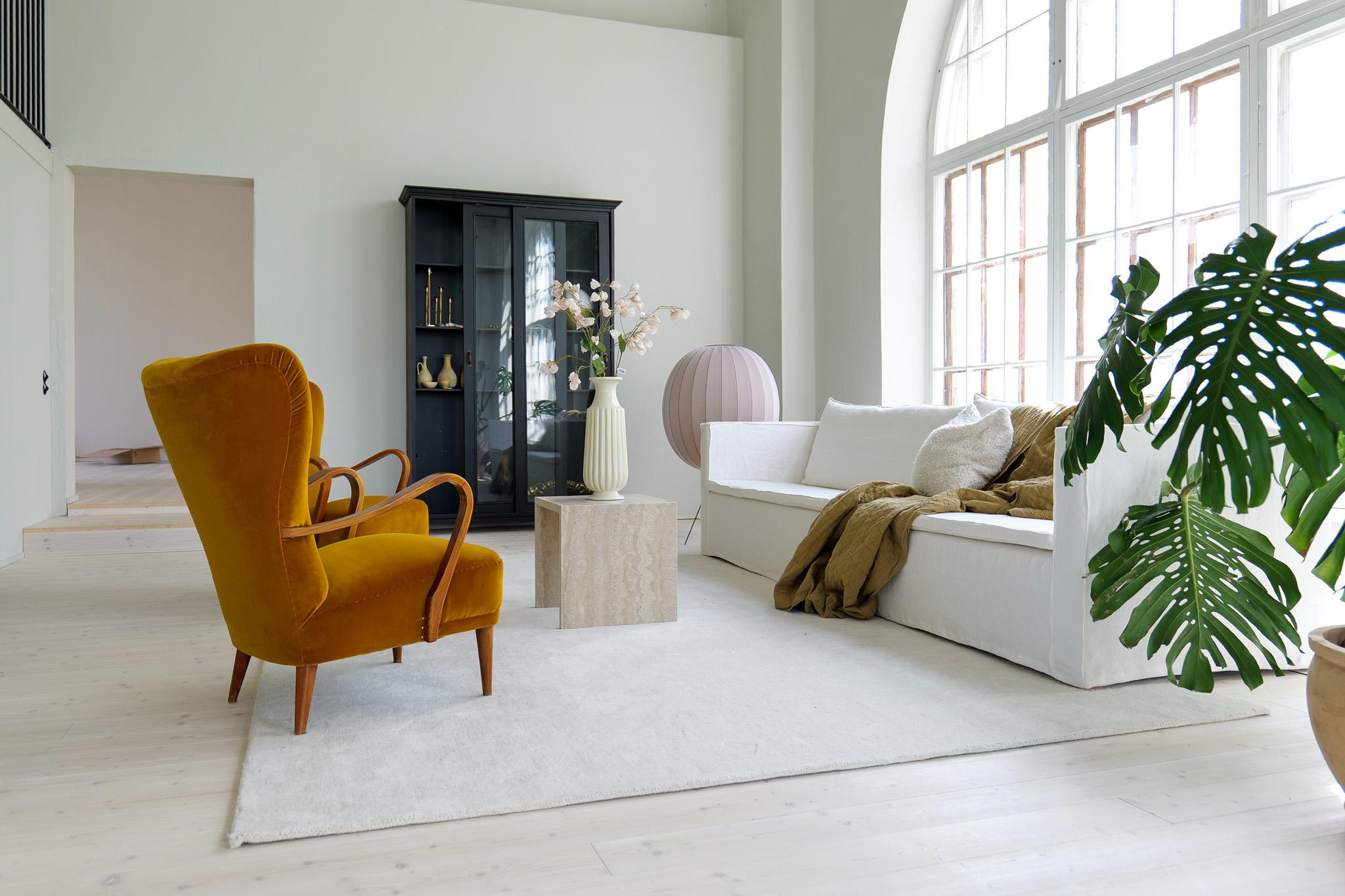 A wonderful pair of wingback chairs made in Sweden during the 1940s. 
The shape and structure together with the wooden armrest give these chairs a sophisticated and modern look. 

To give the chairs a fresh and exclusive look they have been