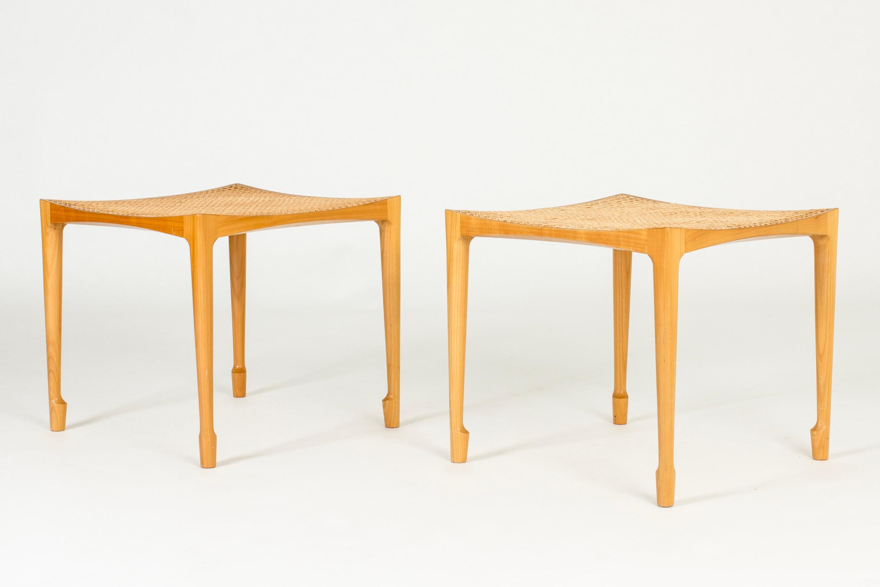 Pair of beautiful birch and rattan stools by Bernt Petersen. Beautiful, slender design with sculpted legs and seats that are subtly concave.