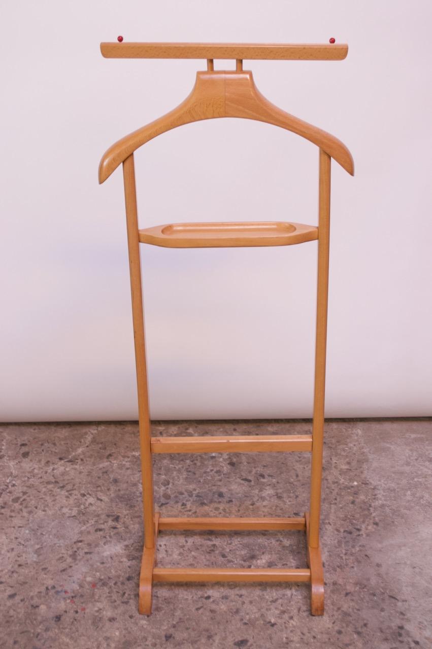 Unique circa 1960s Scandinavian valet composed of a frame/hanger and change or cufflink holder with a double rack on the bottom for shoes. There is an interesting red double hook attachment for hanging ties, shirts, etc., offering a nice pop of