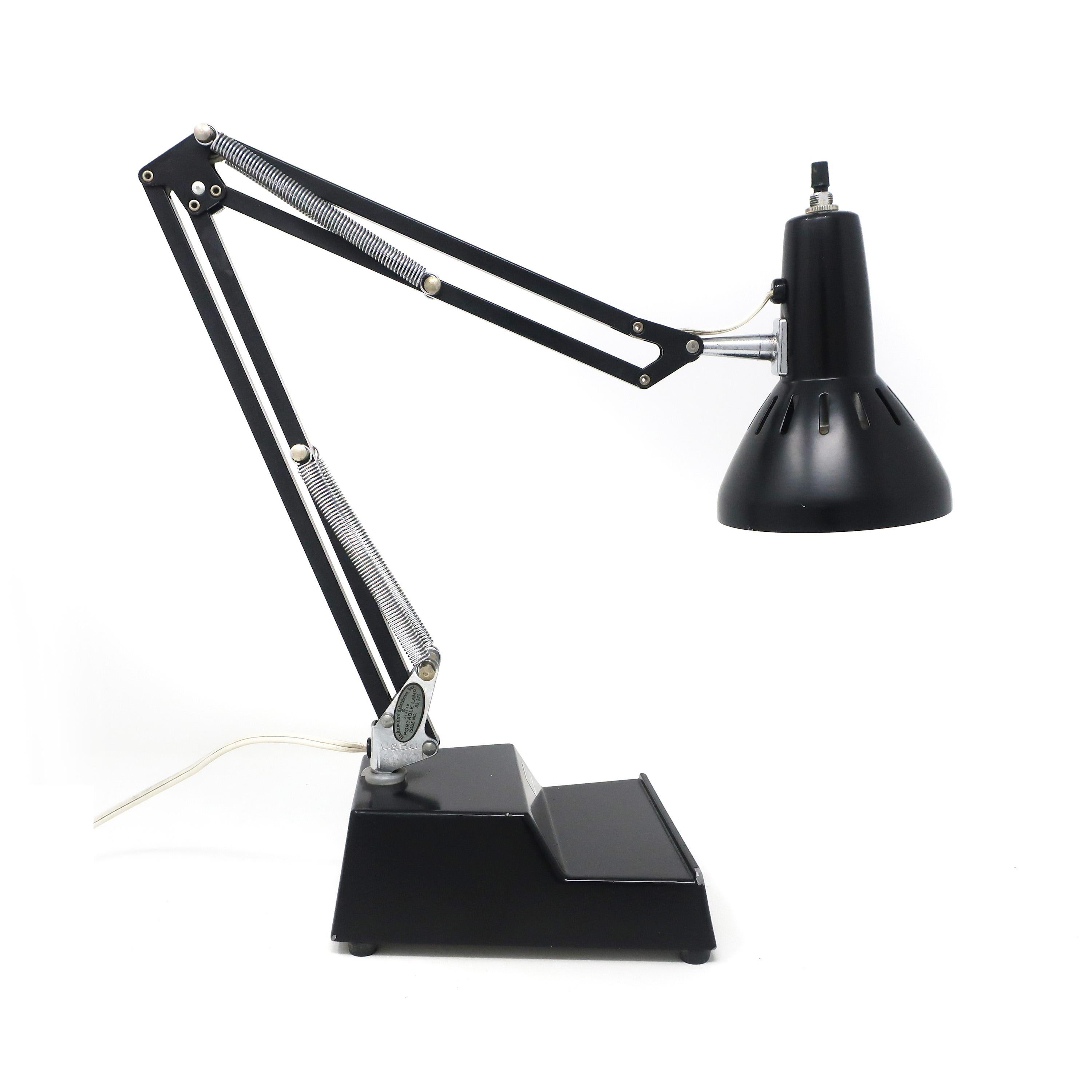 A vintage ledu adjustable desk lamp with black base, stem, and shade and chrome accents. A similar style to the Luxo L-1 lamp but with a weighted metal base. A classic design that still looks modern today! 

In very good vintage condition with
