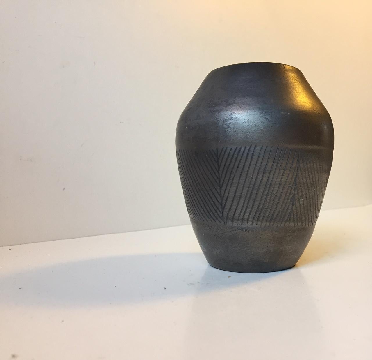 Slate black Scandinavian vase with diagonal incisions, pin-stripes. Designed by an anonymous ceramist in Scandinavia during the 1950s or 1960s. It was possibly created at either Höganäs or Uppsala Ekeby both of which had ceramic pieces leave the