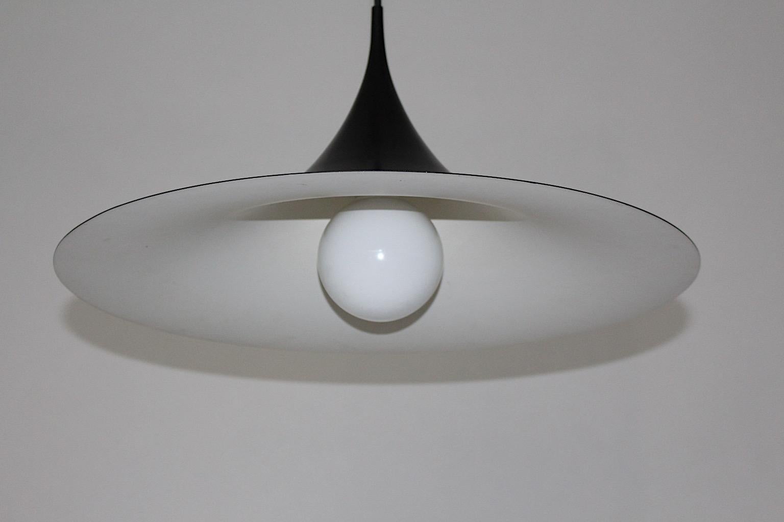 Scandinavian Modern enameled black vintage pendant or chandelier Semi designed by Claus Bonderup & Torsten Thorup, 1967, Denmark.
Beautiful iconic design in good vintage condition.
The surface is from black metal, while the inside shows white