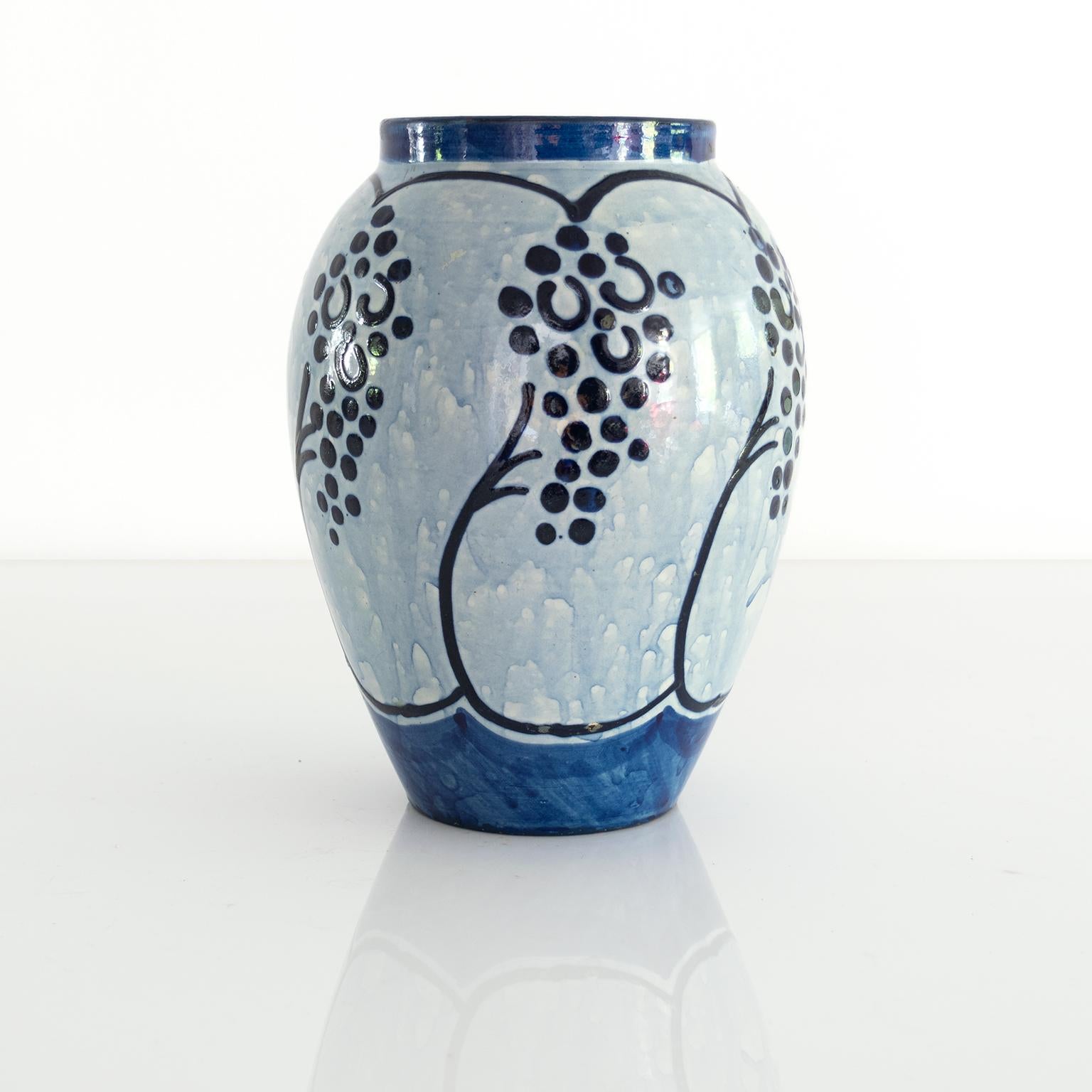 A Scandinavian Modern, Swedish ceramic vase in blue glazes decorated with grapes or berries. Made by Upsala Ekeby. 

Measures: Height: 8.5” Diameter: 6”.