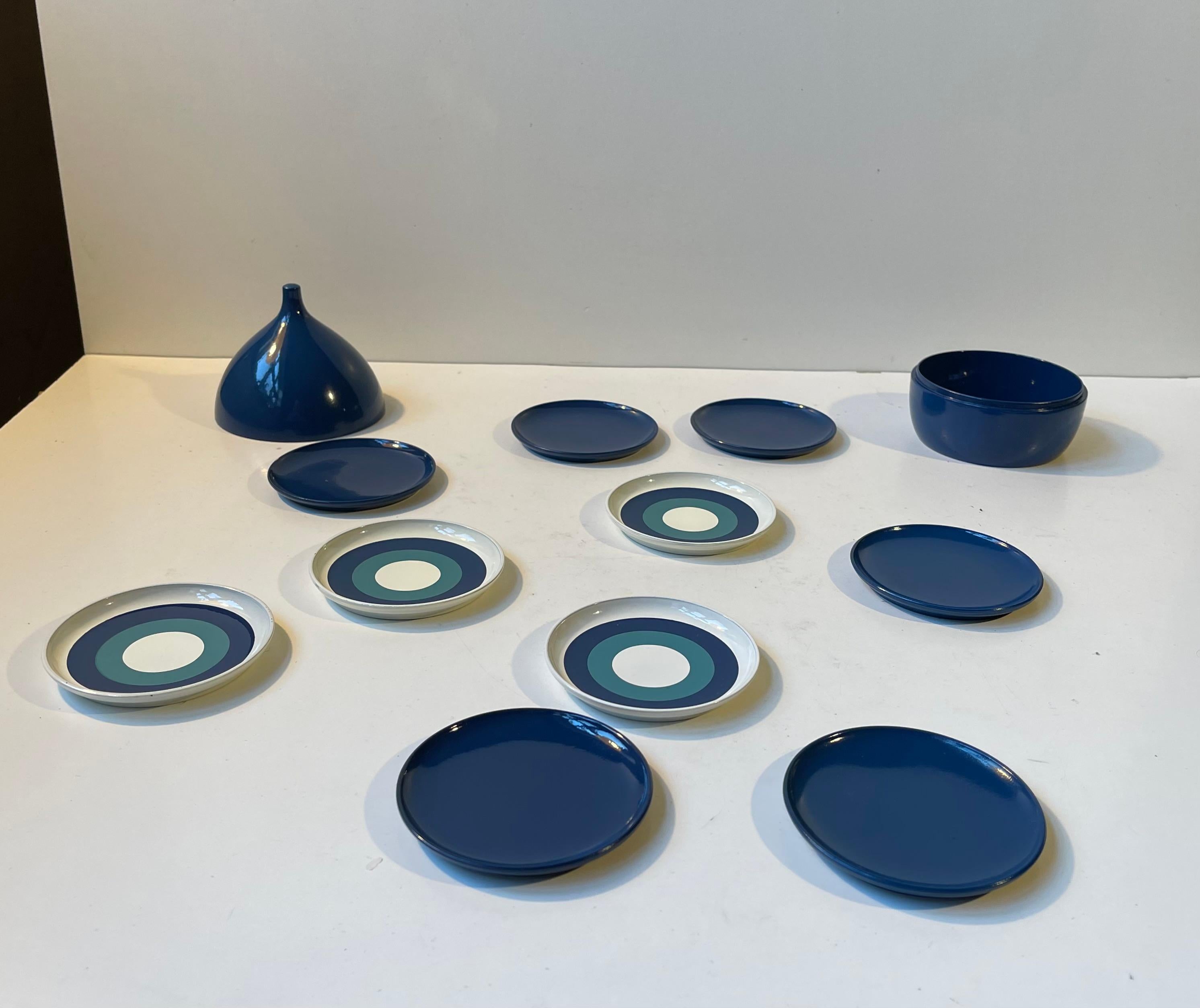 A set of painted resin coasters for drinks, coffee or tea. The set comes in its original onion shaped jar. Designed and manufactured by Laurids Lønborg in Denmark during the 1960s. The price is for all 10/11 (container) pieces. Measurements: H: 10