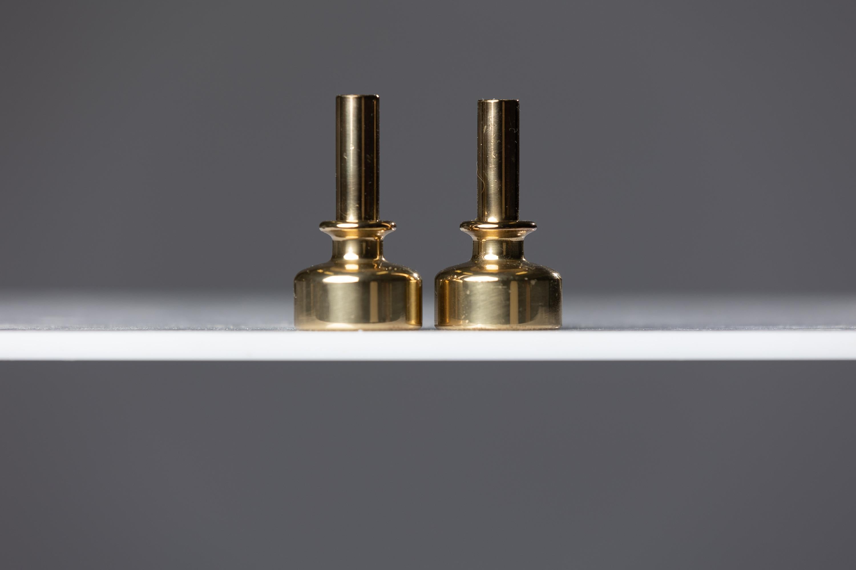 Immerse yourself in the timeless beauty of Hans-Agne Jacobson brass candlesticks, a quintessential embodiment of a Modern style from the mid-century era. Crafted with exceptional artistry and attention to detail, these brass candlesticks exude an