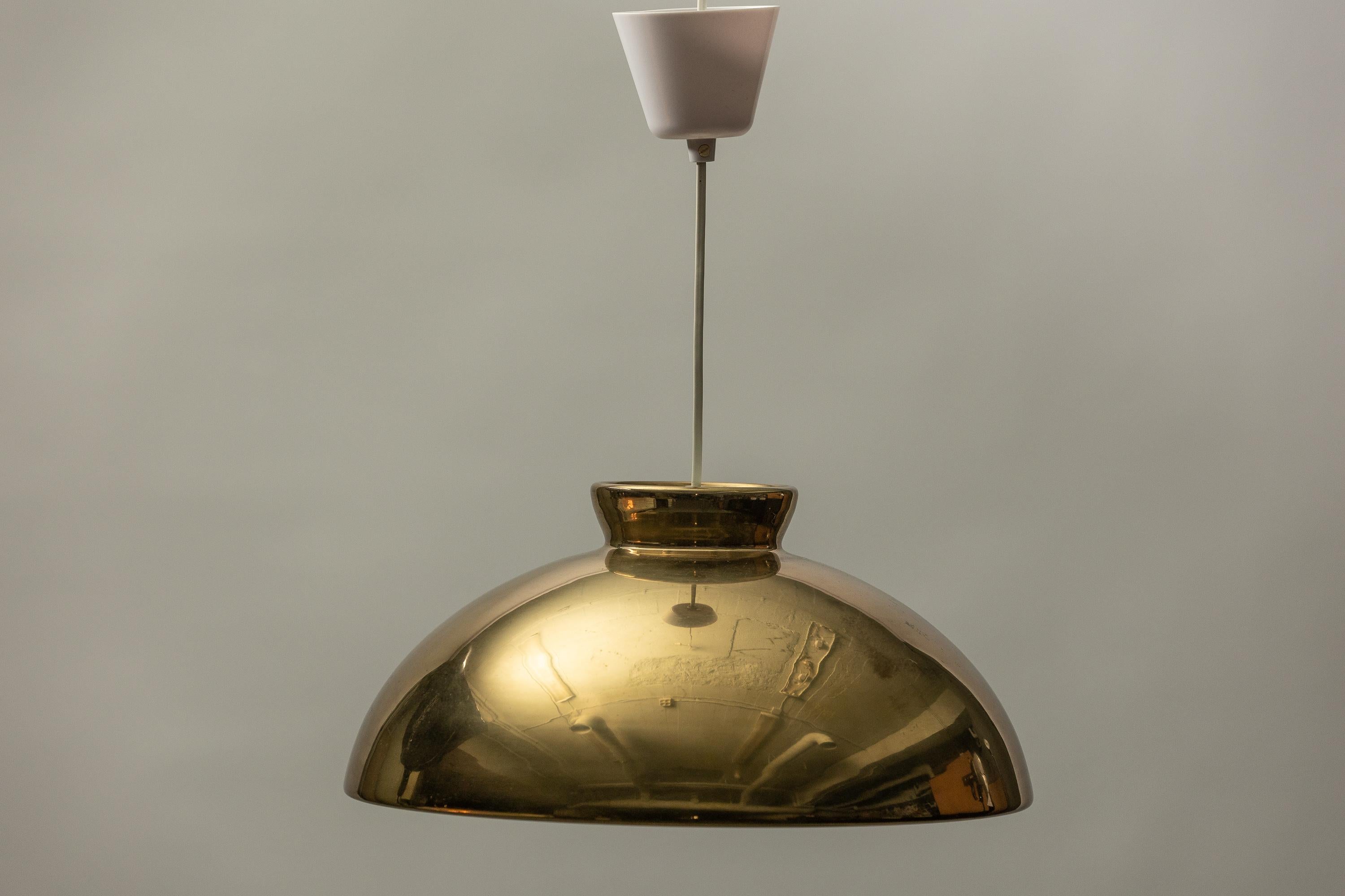 Elevate your space with the captivating Scandinavian Modern ceiling lamp in brass, a masterpiece by Bergboms that embodies the essence of timeless design. Crafted meticulously, this iconic piece seamlessly marries form and function, making it a
