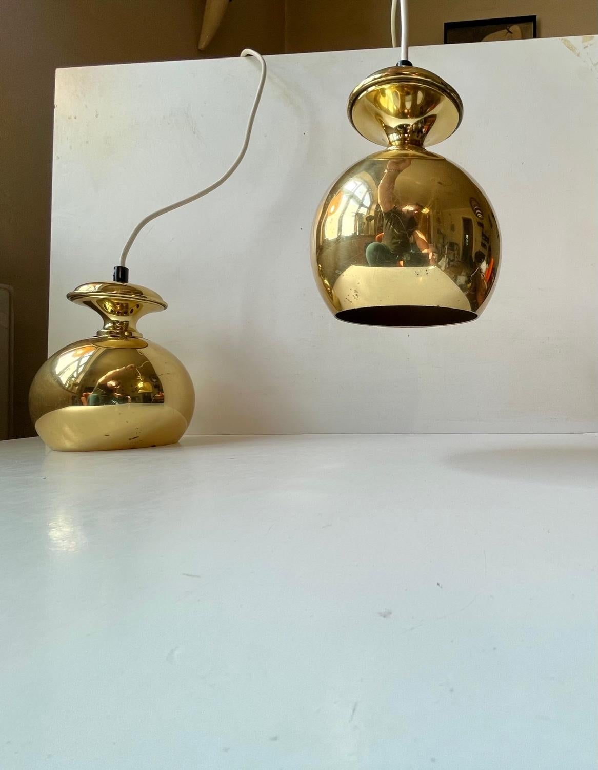 Pair of bell shaped pendant ceiling lights designed by Hans-Agne Jakobsson for Markaryd Sweden, 1960s. They feature solid brass top and shade with a reflective golden interior. Suitable for kitchen, cosy corner lightning, over your midcentury desk