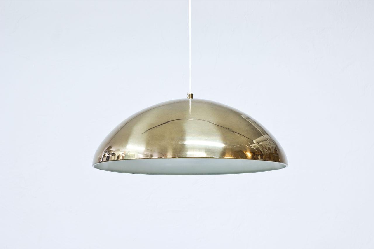Pendant lamp model T–29 manufactured by Bergboms in Sweden during the 1960s. Made from brass with opaline glass diffuser.
