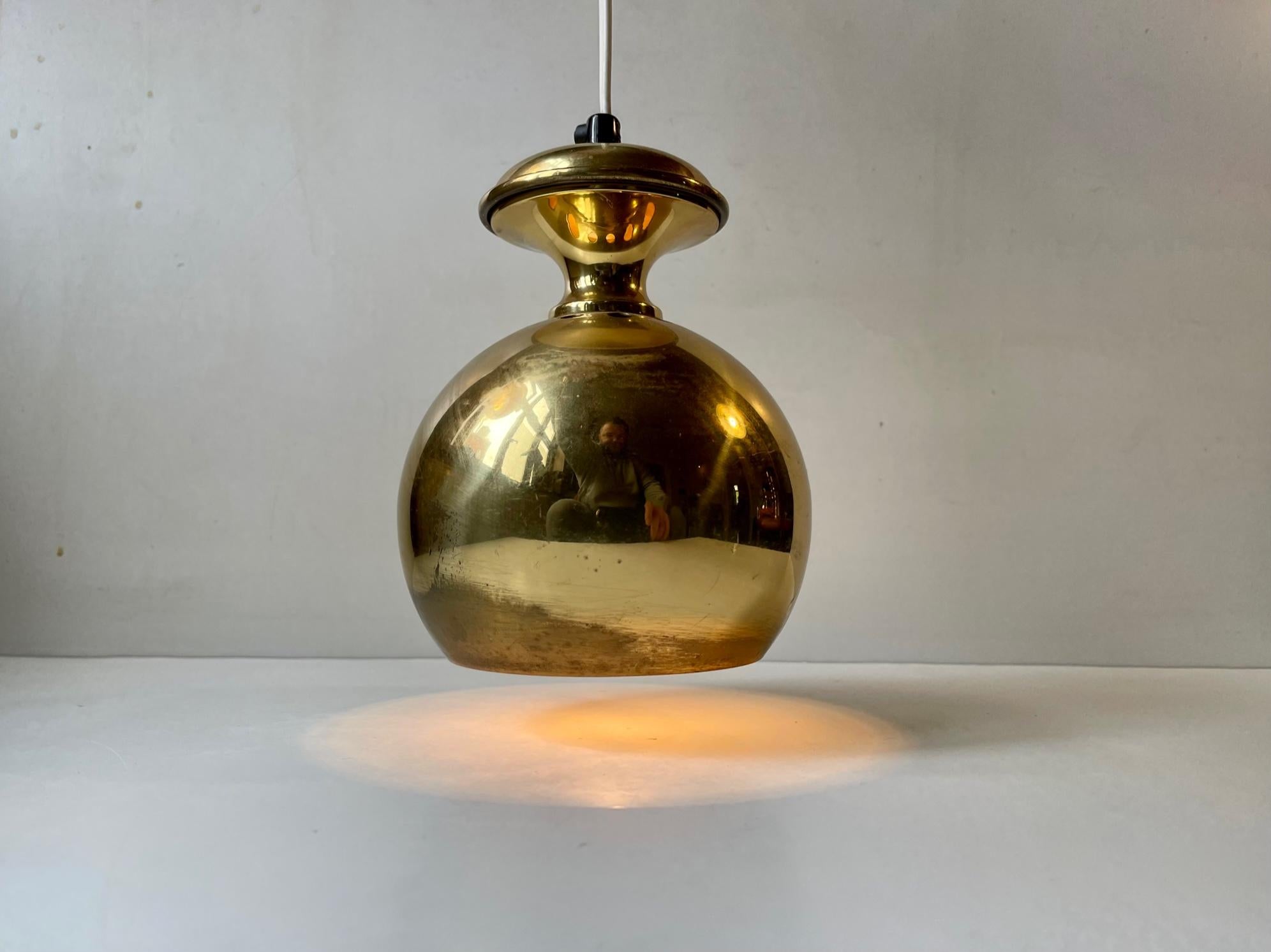 Unusual diablo shaped ball - round - spherical pendant light in brass. Designed and made by ABO Art Metal Studio in Randers, Denmark circa 1970. The style is reminiscent og Hans Agne Jakobsson and Paavo Tynell. Measurements: H: 19 cm, Diameter: 14