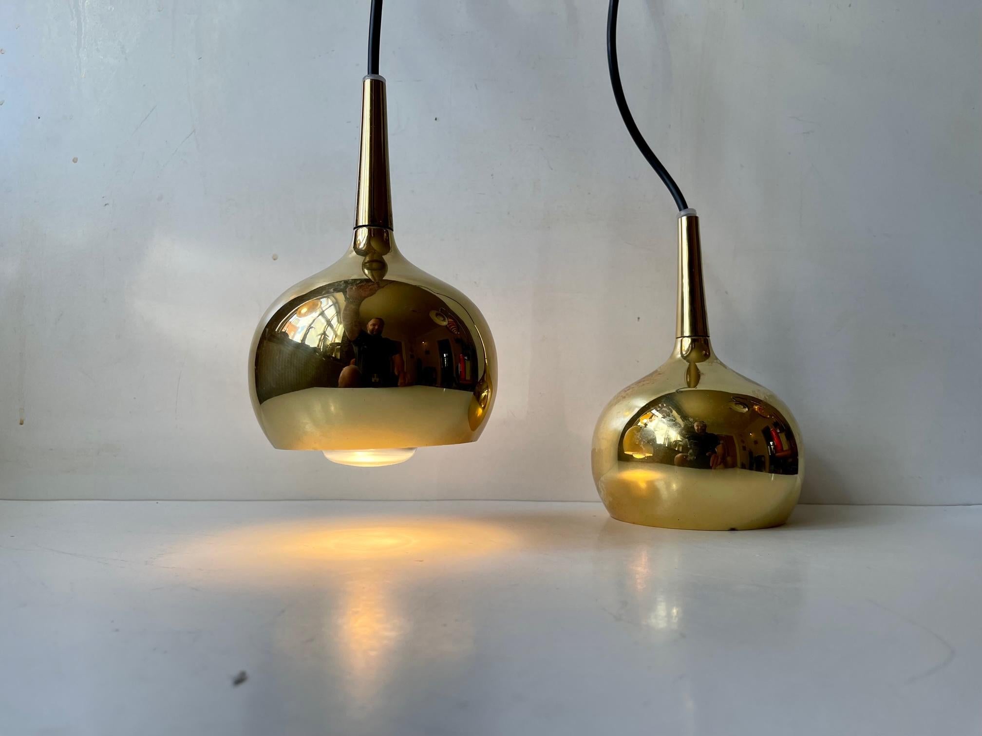 A pair of small onion shaped pendant ceiling lights designed by Hans-Agne Jakobsson for Markaryd in Sweden during the 1960s. They feature a solid brass top/tube and a gold-chrome main shade with white reflective interior. Suitable for kitchen, cosy
