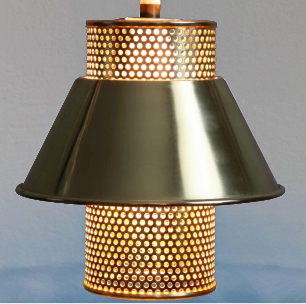 A set of brass pendant lamps with perforations for a nice lighting effect. 

Hans-Agne Jakobsson was a Swedish interior and furniture designer, who ran his own company from 1951. Jakobsson was especially famous for his lighting designs, which often