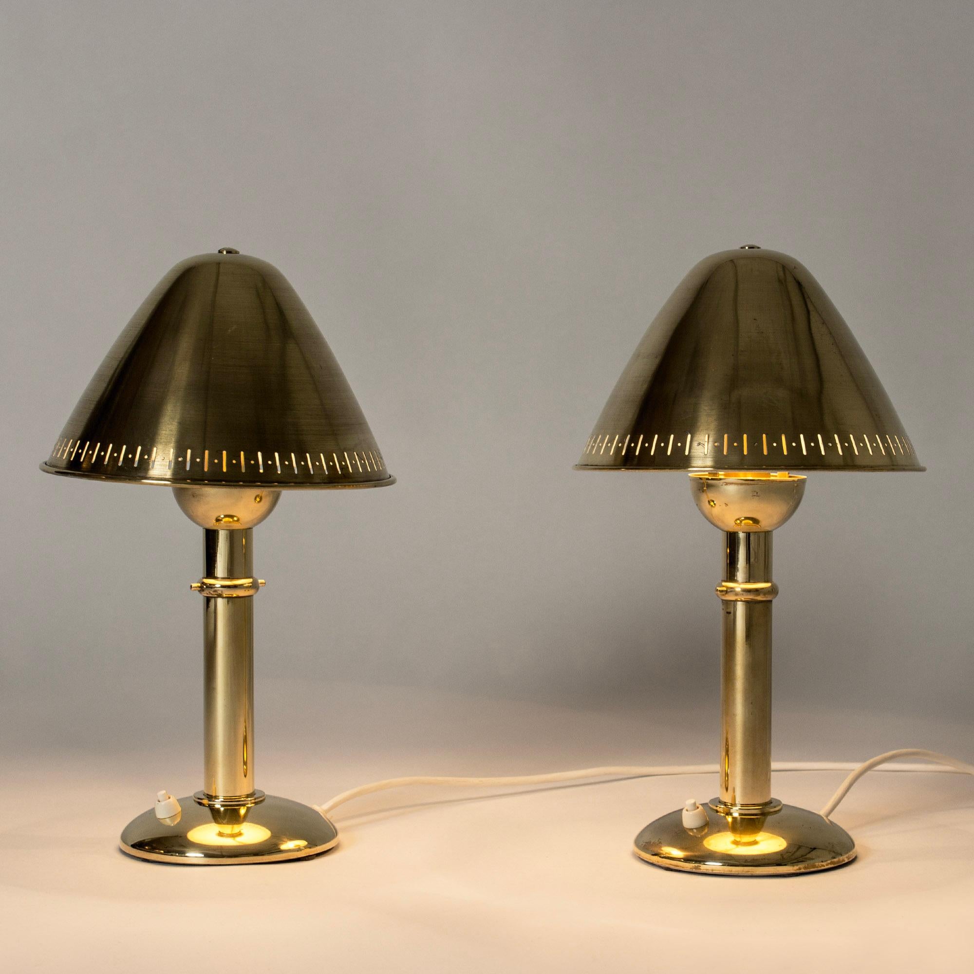 Pair of striking table lamps from ASEA, made completely from brass. Cool, clean design with shades that can be adjusted to direct and soften the light.