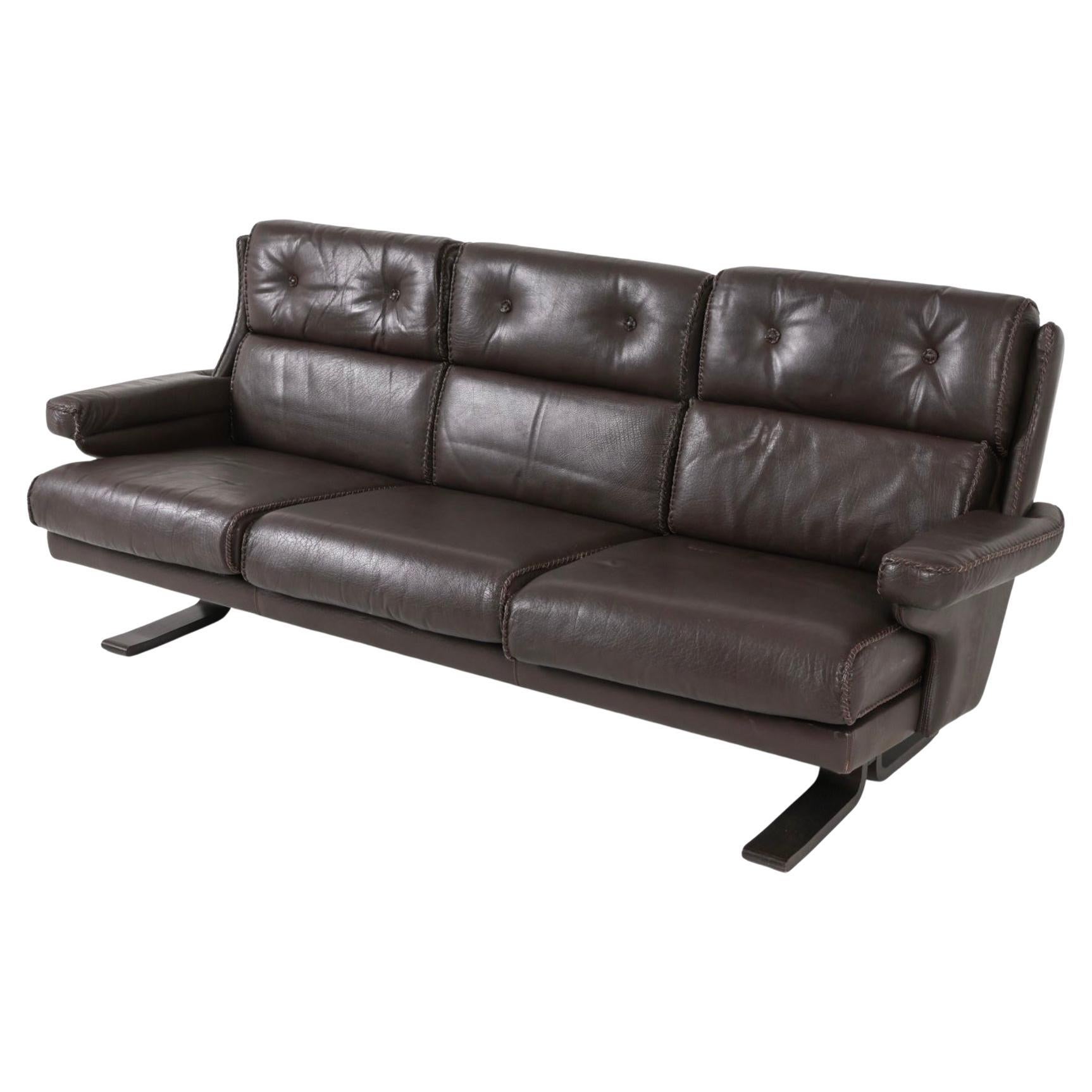 Scandinavian modern Brown leather 3 seat sofa style of Arne Norell Sweden. Brown leather upholstery and cushions with woven leather stitches. Beech Bentwood runner legs. Made in Sweden circa 1970.

Dimensions: H 32