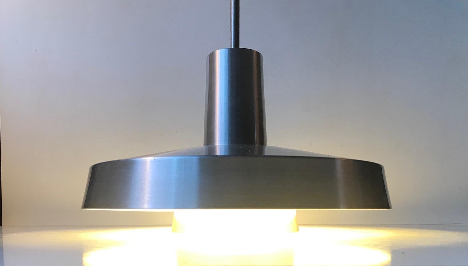 A rare brushed aluminium pendant light from Lyfa in Denmark. It is called Top 2 and was designed in 1972 by husband and wife Eva & Niels Koppel in collaboration with two other danish designers; Erik Thyring and Gert Edstrand. It suitable for