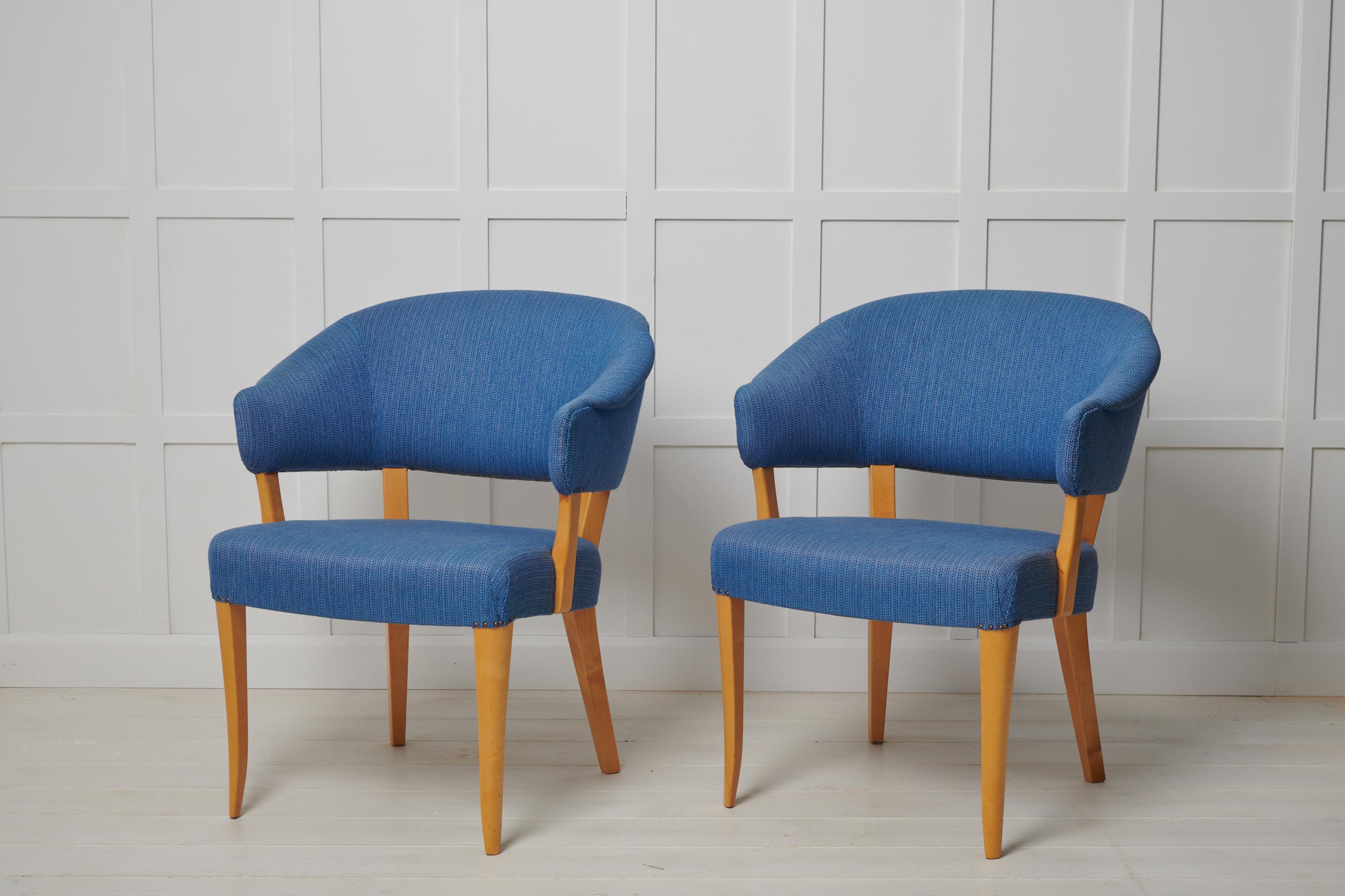 Scandinavian modern “Lata Greven” chairs designed by Carl Malmsten around 1953. This particular pair is likely made during the later years of the 1900s. Produced by O.H Sjögren. The name translates to the “lazy count” and the chairs are a classy but