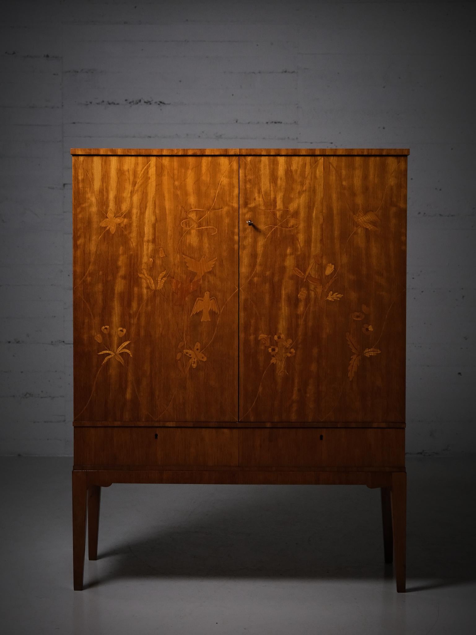 Rare cabinet produced by Möbelbolaget Tranås, Sweden, during the 1940s. 

Made in mahogany with a beautiful floral and bird inlay. 