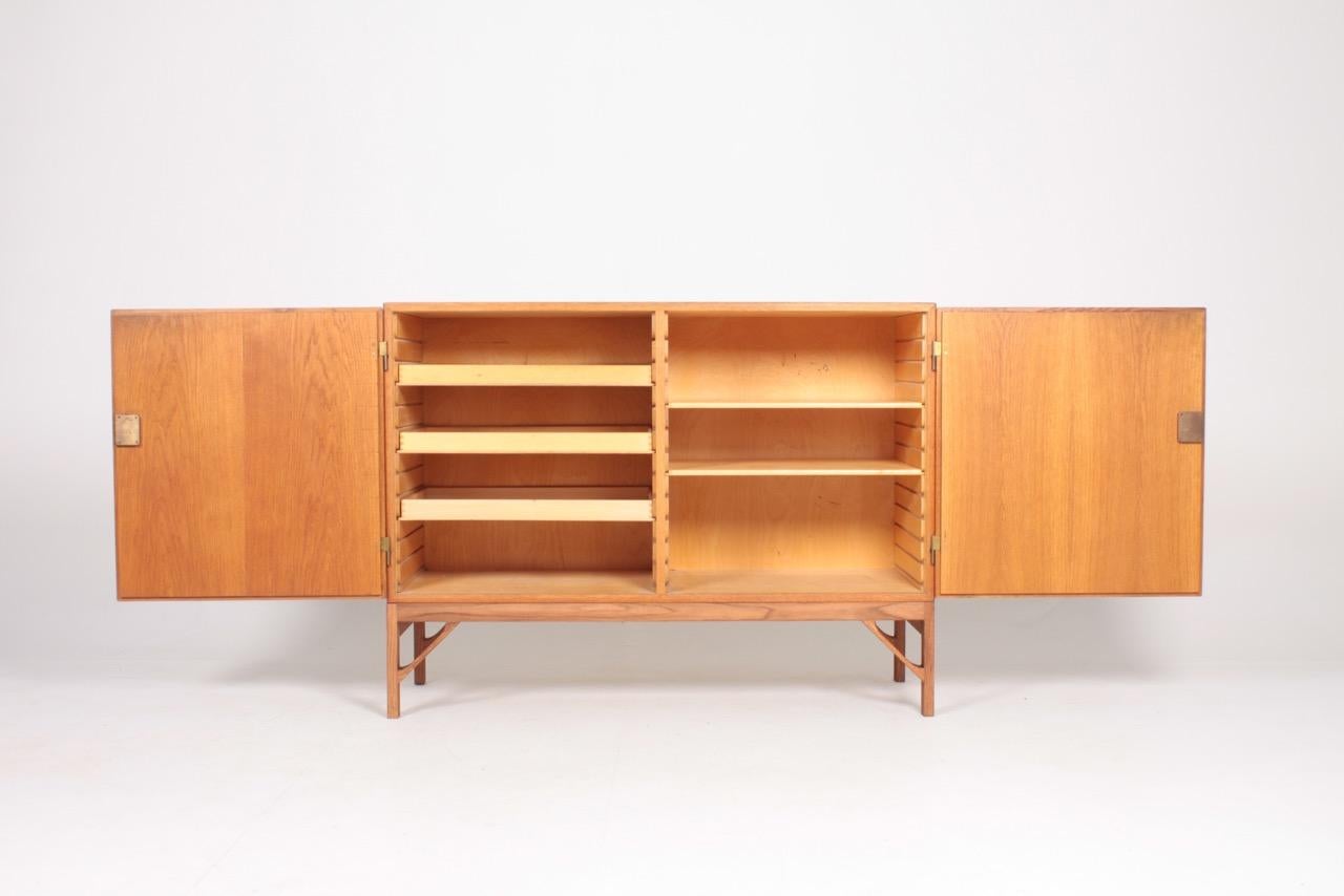 China cabinet in all oak with stunning brass hardware and maple Interior. Designed by MAA. Børge Mogensen in 1958, this piece is made by CM Madsen cabinetmakers Denmark in the 1960s. Great original condition.
