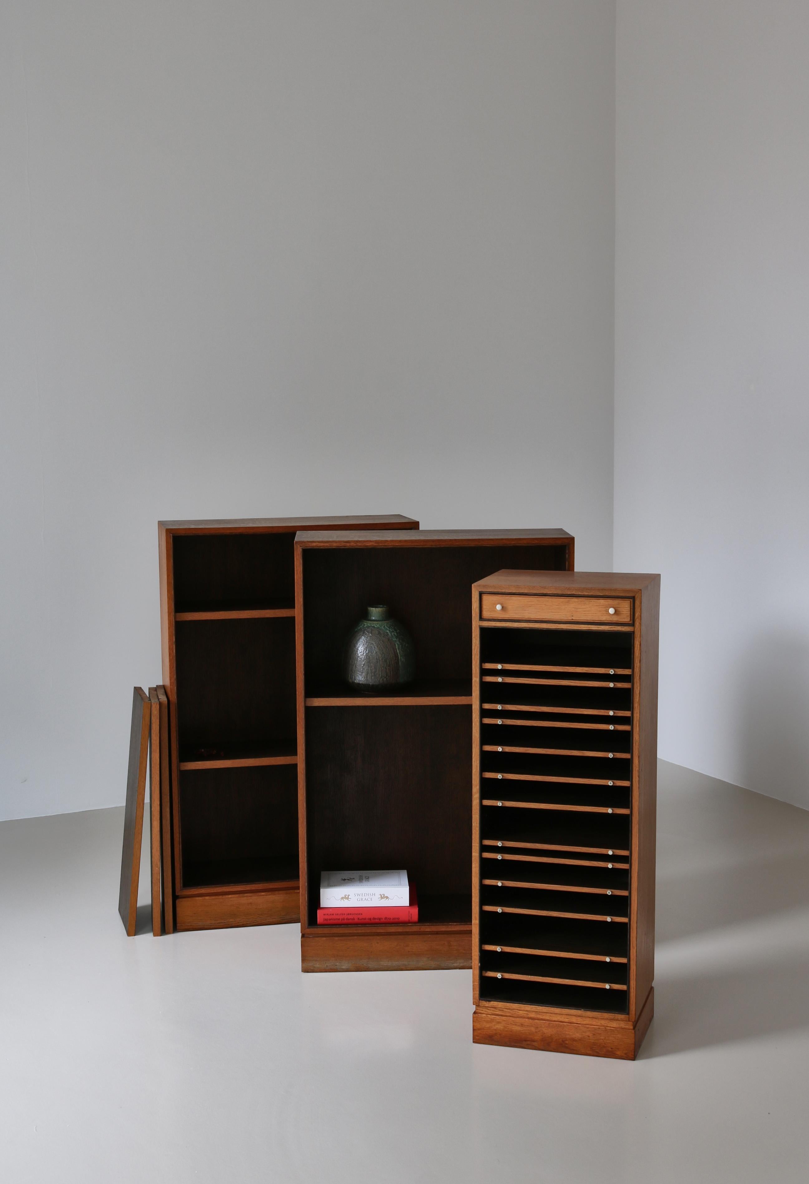 A decorative oak cabinet made by Danish cabinetmaker I.P. Mørck, Copenhagen in the 1930s. The cabinet is simple and functional with adjustable filing shelves and a top drawer with dovetail joints and handles in white bakelite. Elegant handmade