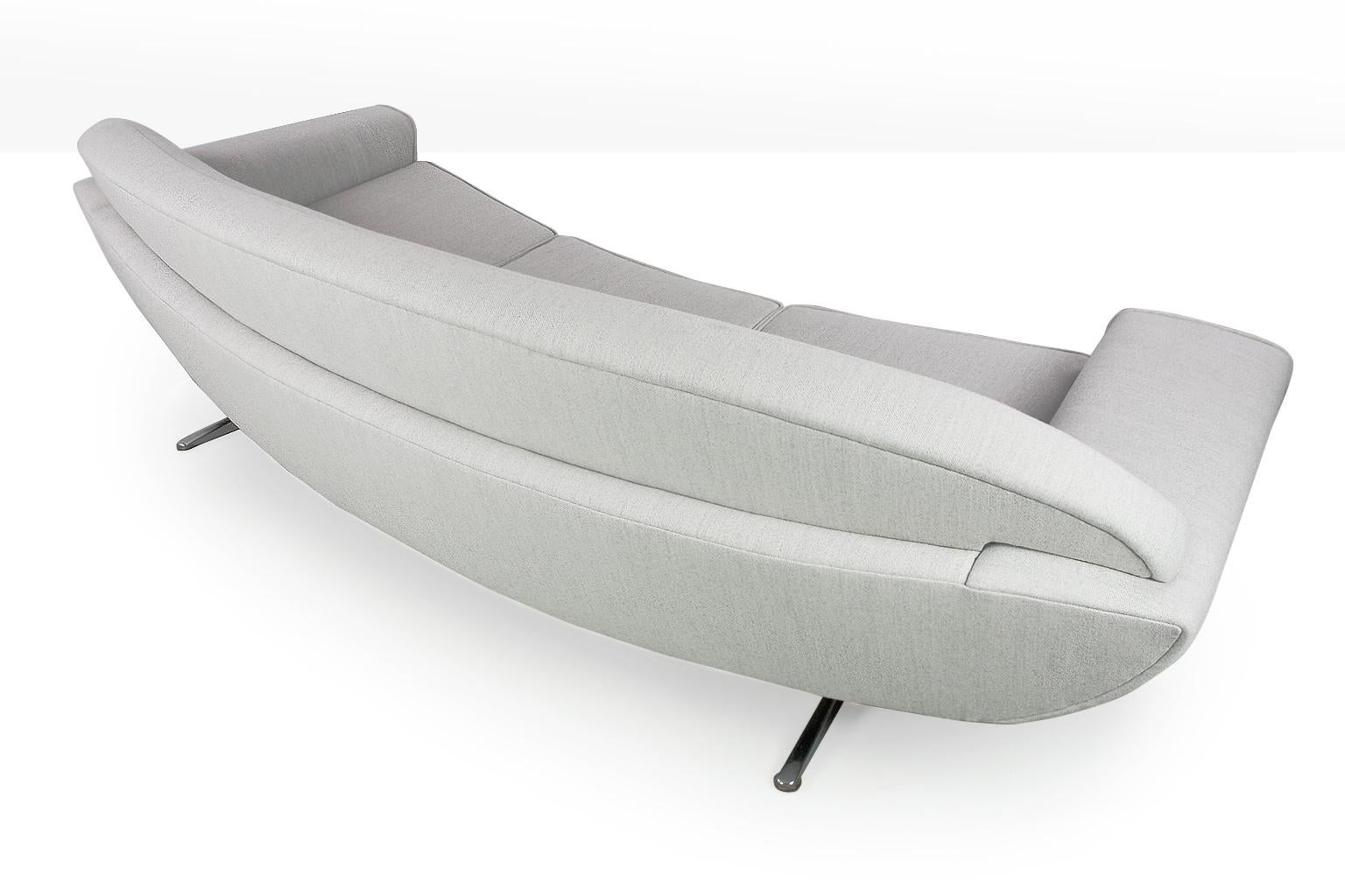 Beautiful boomerang shaped new upholstered 'Capri' sofa on a chromed t-legged frame, designed by Johannes Andersen for Trensum of Sweden in 1958. The sofa is curved, which makes it a elegant stand-alone object in your interior. 

The seat depth is