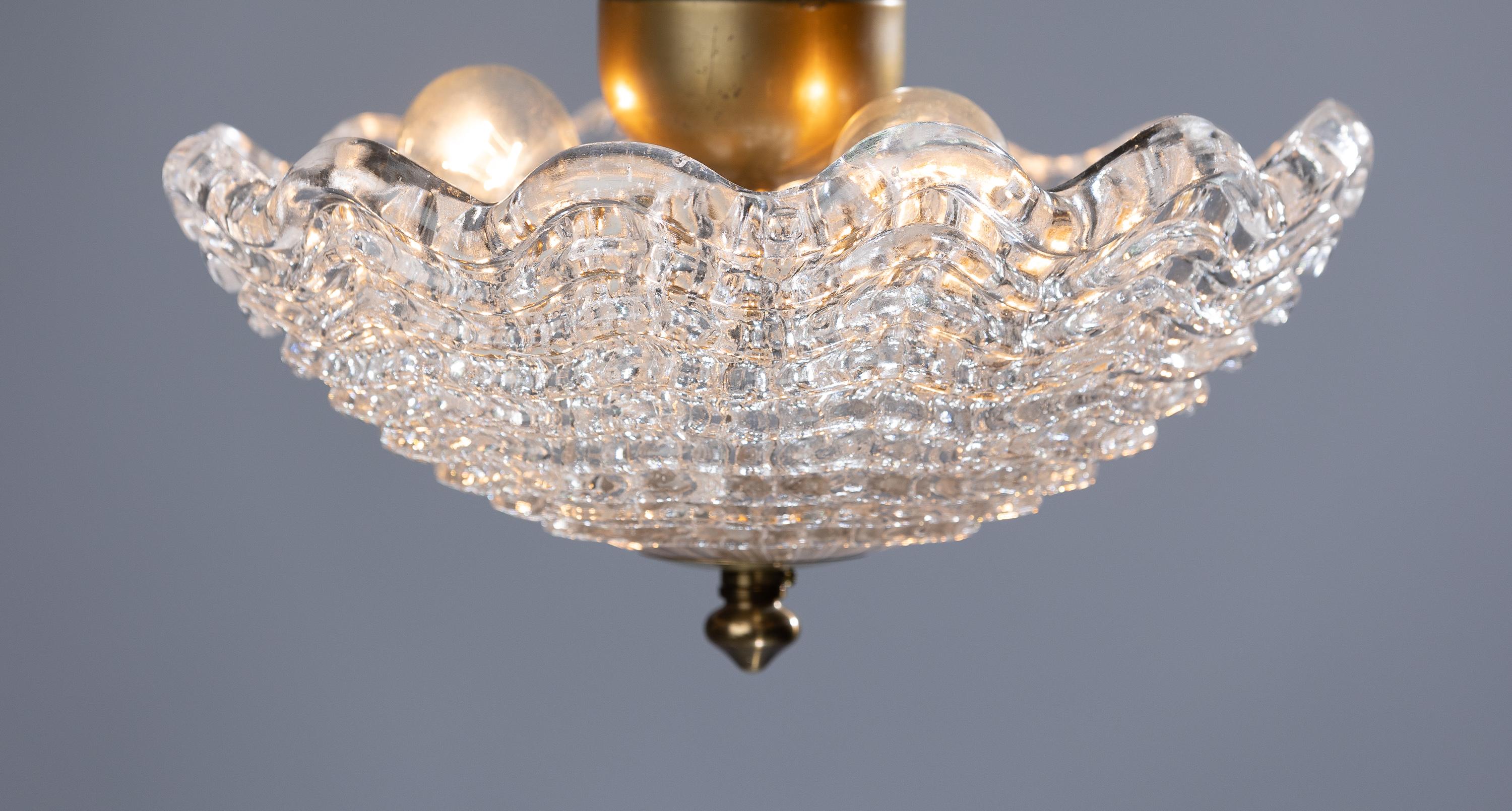 Discover the enchanting charm of the Carl Fagerlund ceiling lamp, an epitome of elegance crafted from pressed glass and brass. This masterpiece seamlessly marries form and function, enhancing your space with its timeless allure.

The Carl Fagerlund