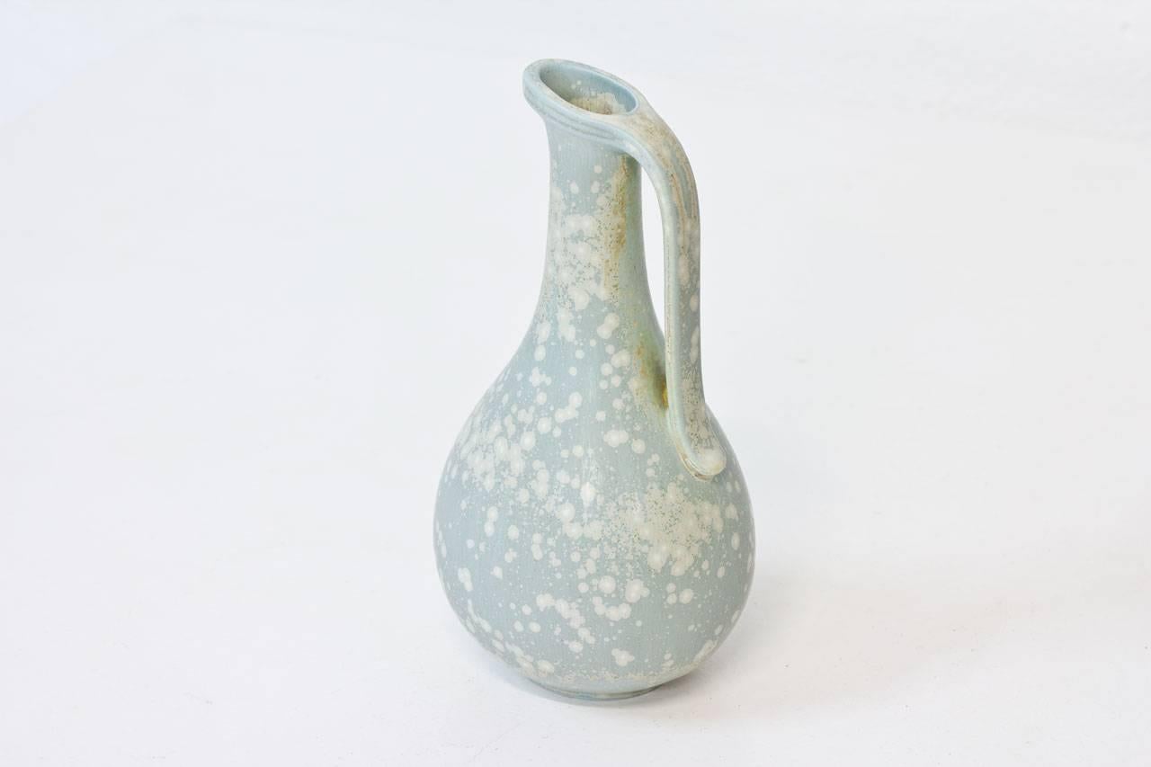 Stoneware jug or vase designed by Gunnar Nylund for Rörstrand. Handmade in Sweden during the 1940s. Matte blue speckled grey glaze with slight touch of green. Hand signed with the initials of ceramist. First line of production in excellent condition.