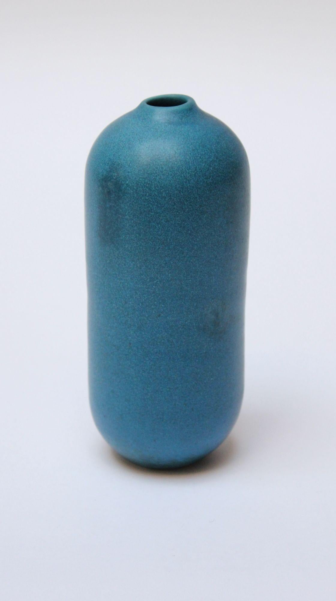 Matte-blue glaze stoneware bullet-form bud vase (ca. 1960s, Scandinavia). Smooth, modernist form with rich textures within the glaze, as shown. Diminutive size: H: 6.25